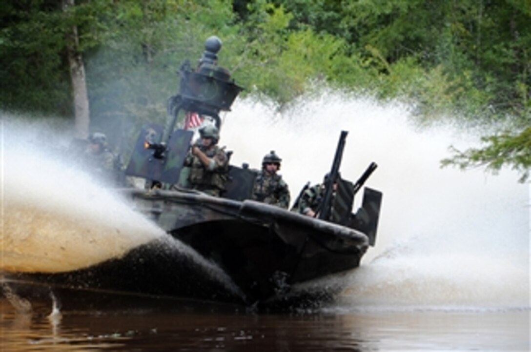 U.S. Navy special warfare combatant-craft crewmen from Special Boat Team 22 drive a special operations craft-riverine at the John C. Stennis Space Center in Mississippi on Aug. 16, 2009.  Special warfare combatant-craft crewmen are U.S. Special Operations Command maritime mobility experts.  