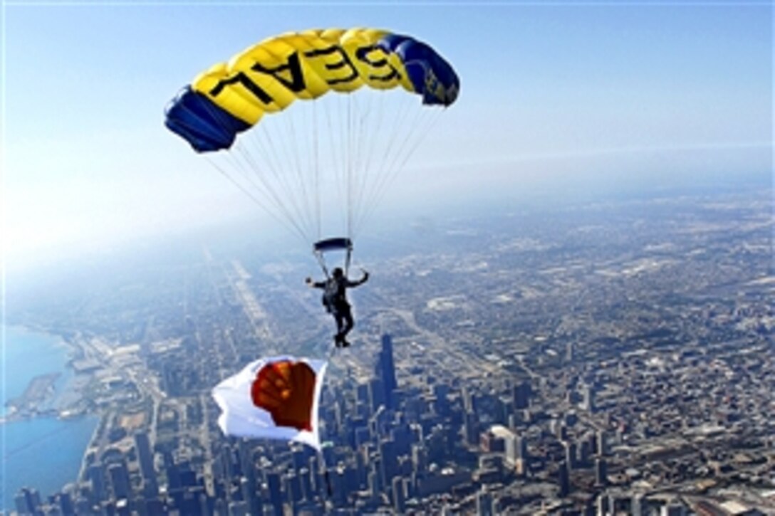 U.S. Navy Chief Petty Officer Justin Gauny parachutes above Chicago during a practice jump for the 51st Annual Chicago Sea and Air Show, Aug. 14, 2009. Gauny is a Navy SEAL assigned to the U.S. Navy Parachute Team, the Leap Frogs, which performed a jump alongside the U.S. Army Parachute Team, the Golden Knights. The Leap Frogs are based in San Diego and perform at various locations across the country to showcase Navy excellence and raise awareness about Naval Special Warfare. 