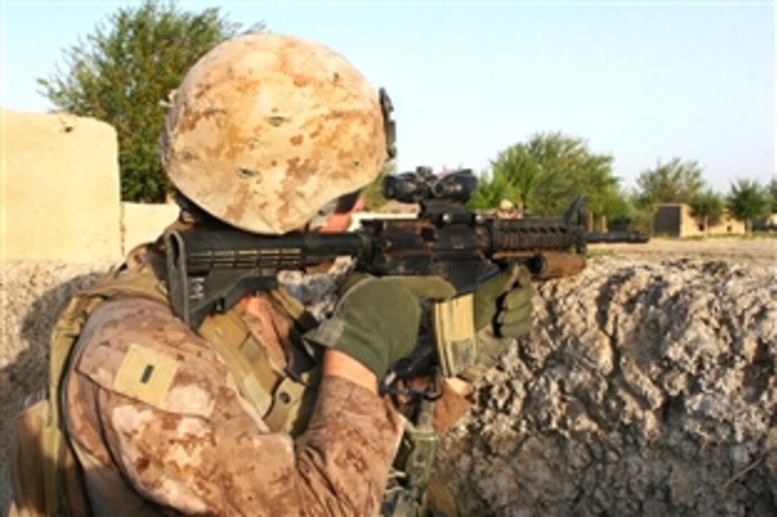 U.S. Marine Corps 1st Lt. Thomas Tompkins scans for enemy positions with his rifle combat optic scope while on patrol in Garmsir district in Helmand province, Afghanistan, Aug. 10, 2009. Tompkins is assigned to Echo Company, 2nd Battalion, 8th Marine Regiment.