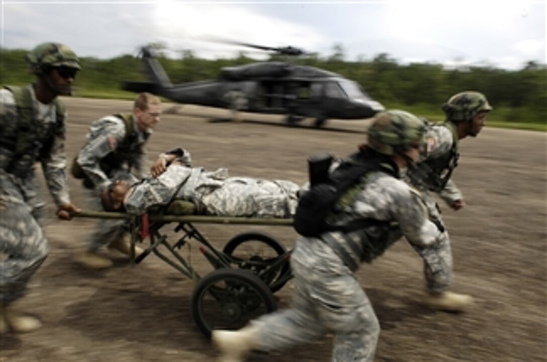 U.S. Army soldiers from the 349th Combat Support Hospital off-load a mock patient during an exercise at the Joint Readiness Training Center at Fort Polk, La., on Aug. 17, 2009.  The Joint Readiness Training Center provides realistic training using scenarios that allow integration between joint military organizations, host nations and civilian role-players.  Units from the U.S. Air Force, Army and Marine Corps and units from the Canadian and Belgian air forces are training together during the exercise to provide quality care to sick and injured personnel in real-world environments.  