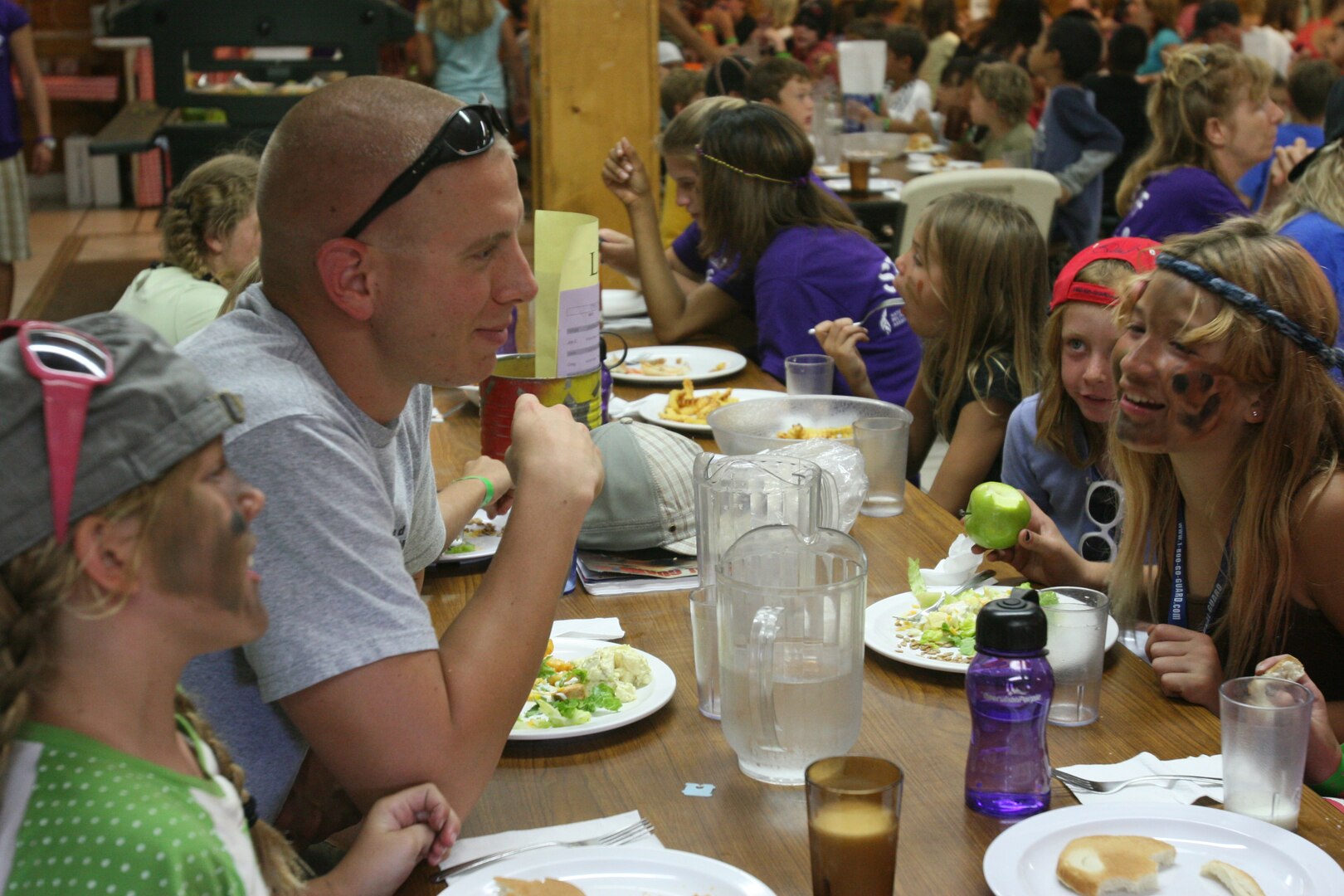 Sgt. Zachary Dyer, the platoon sergeant at the Consolidate Public Affairs Office here, spends time with a group of children on military appreciation day at "Operation Purple." Operation Purple is a camp for children of deployed service members.