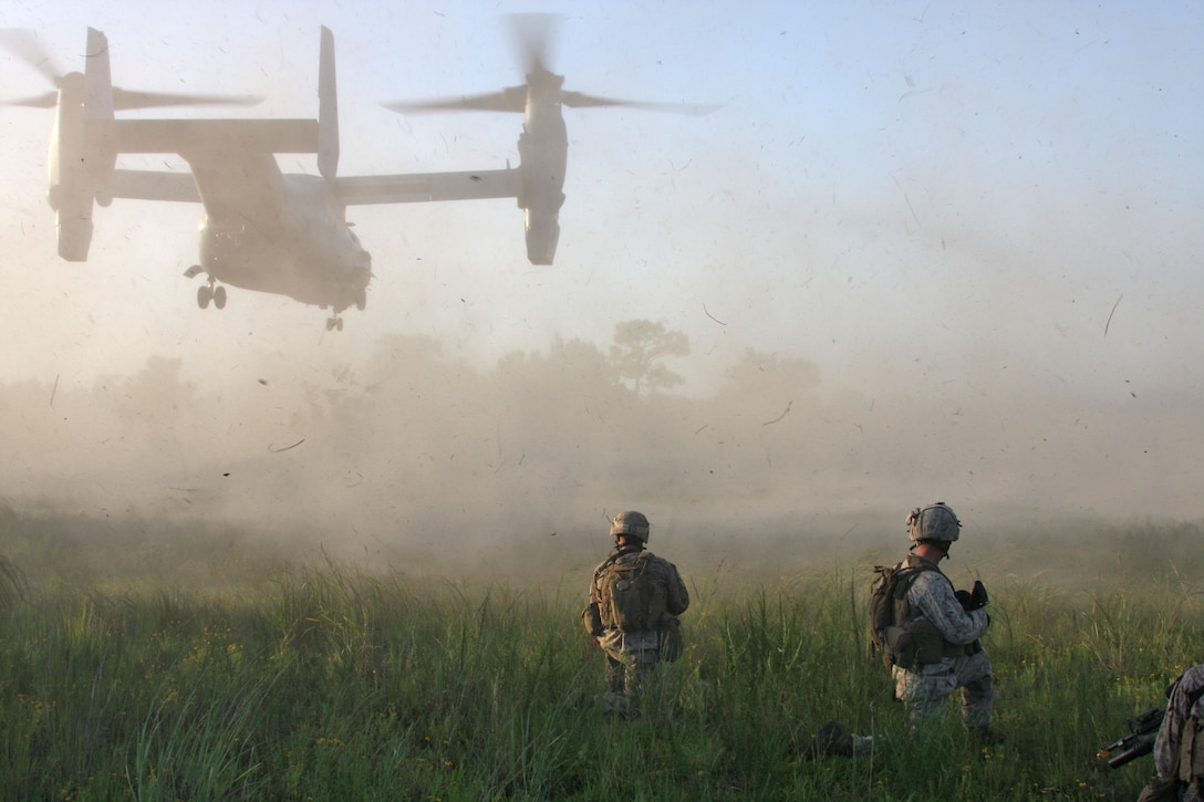 Marines from 1st platoon, Charlie Company, Battalion Landing Team 1st Battalion, 9th Marine Regiment, 24th Marine Expeditionary Unit, establish security around a landing zone for a MV-22 Osprey, from Marine Medium Tilt Rotor Squadron -162, 24th MEU, to medically evacuate casualties from the Heliborne Company Raid Course at Camp Lejeune, N.C. Aug. 19.  Charlie Company trained with Special Operations Training Group to become the 24th MEU’s helo raid force for its upcoming deployment.  (U.S. Marine Corps photo by Cpl. Alex C. Guerra)