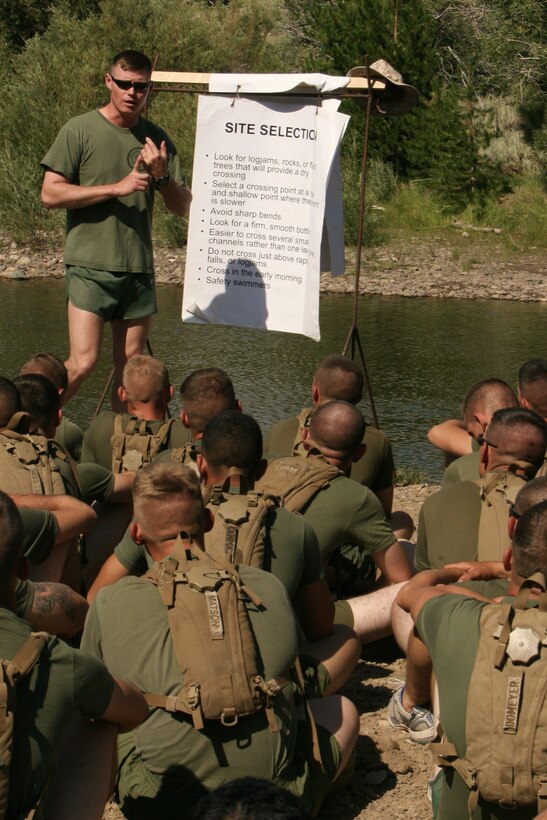 Staff Sgt. Jeremy Miller, a mountain warfare training instructor with the Unit Training Group, teaches a stream crossing class to the Marines and sailors of Company K, 3rd Battalion, 7th Marine Regiment, at the Leavitt Training Area here Aug. 20. Miller, a Chalmette, La., native, said the class provided the unit a basic knowledge of how to safely and tactically cross small rivers and streams.