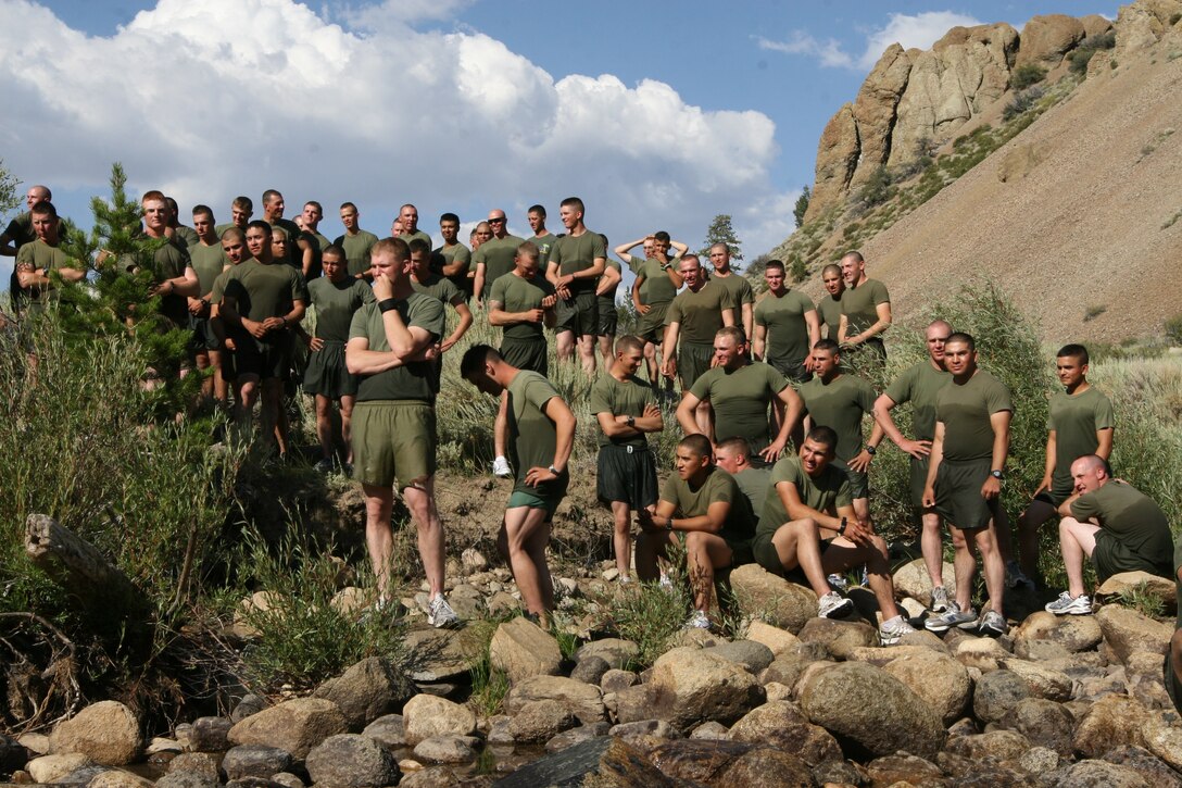 Marines and sailors of Company K, 3rd Battalion, 7th Marine Regiment, watch as other members of the unit conduct a stream crossing exercise at the Mountain Warfare Training Center’s Leavitt Training Area here Aug. 20. The company hiked nearly four miles through hills and ridges to get to the training area.