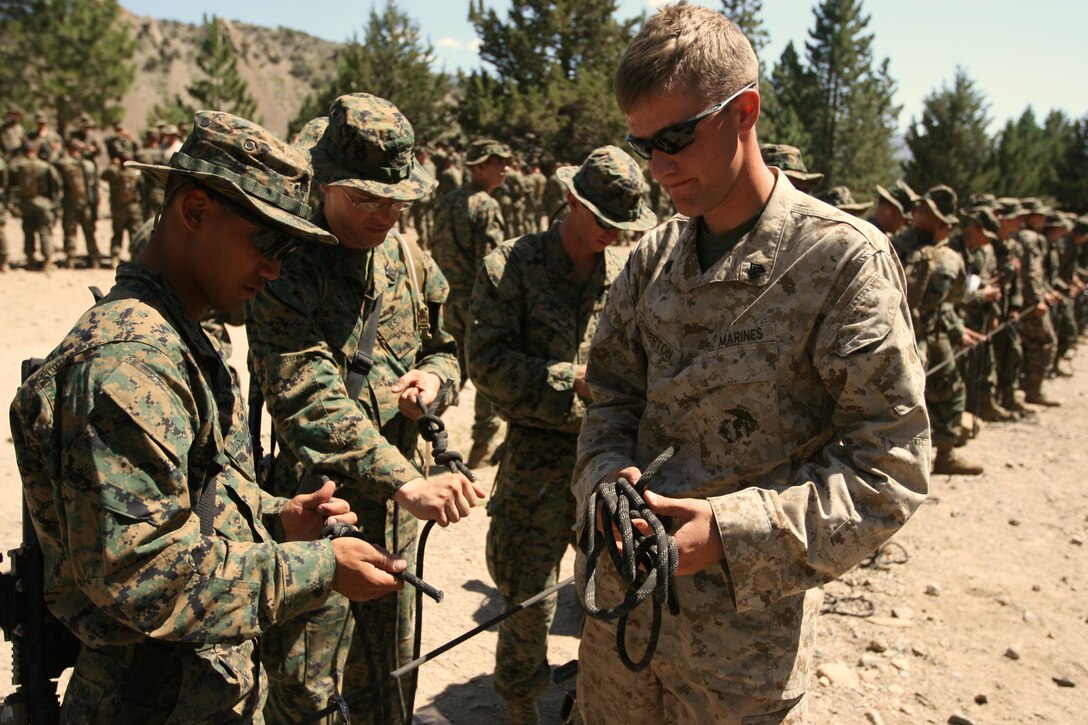 Sgt. Zachary J. Pemberton, an instructor with the Unit Training Group, inspects Marines’ newly learned knot-tying skills during a knot-tying class at the Leavitt Training Area here Aug. 20. Thanks to UTG Marines, units have the opportunity to learn important mountain skills they would not likely receive elsewhere.