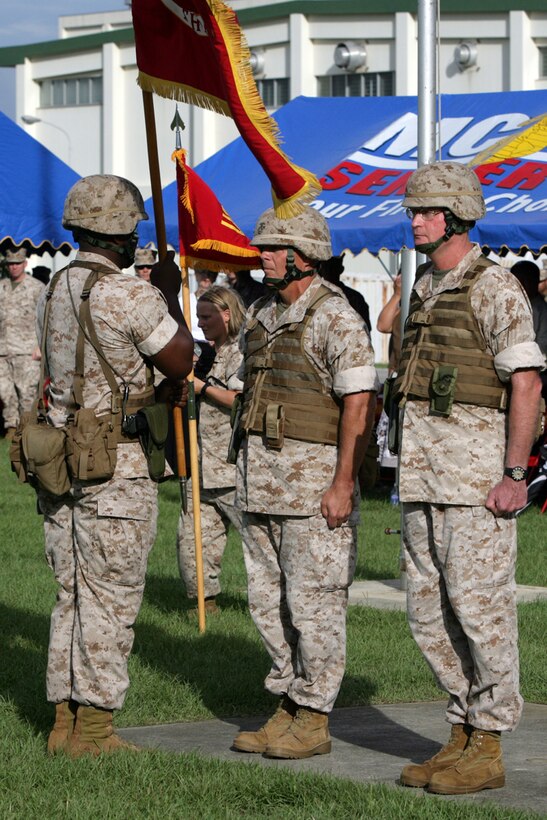 U.S. Marine Maj. Gen. Robert Neller, outgoing Commanding Officer, relinquishes command to Brig. Gen. James Laster, incoming Commanding Officer, during the 3D Marine Division Change of Command Ceremony, on Camp Hansen, Okinawa, Japan, Aug. 20, 2009.  A change of command ceremony is a formal change over of duties from one commanding officer to another in the presence of the unit.  (U.S. Marine Corps photo by Cpl. John A. Chretien/Not Released)