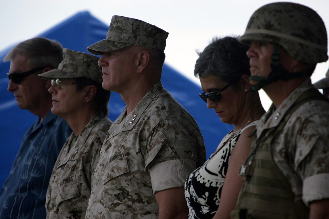 U.S. Marines Maj. Gen. MaryAnn Krusa-Dossin, second from left, Lt. Gen. Richard Zilmer, third from left, and Maj. Gen. Robert Neller, right, stand during the playing of the National Anthem at the 3D Marine Division Change of Command Ceremony, on Camp Hansen, Okinawa, Japan, Aug. 20, 2009.  A change of command ceremony is a formal change over of duties from one commanding officer to another in the presence of the unit.  (U.S. Marine Corps photo by Cpl. John A. Chretien/Not Released)
