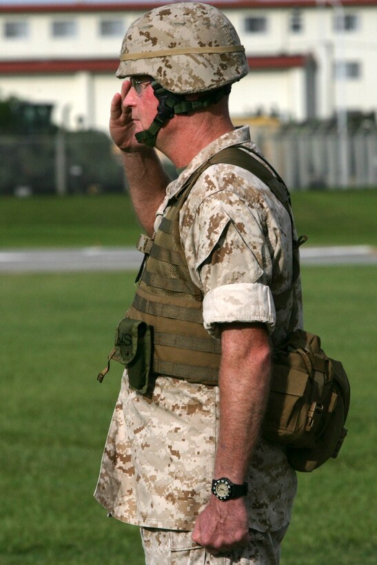 U.S. Marine Brig. Gen. James Laster, 3D Marine Division Commanding Officer stands and salutes during the 3D Marine Division Change of Command Ceremony, on Camp Hansen, Okinawa, Japan, Aug. 20, 2009.  A change of command ceremony is a formal change over of duties from one commanding officer to another in the presence of the unit.  (U.S. Marine Corps photo by Cpl. John A. Chretien/Not Released)