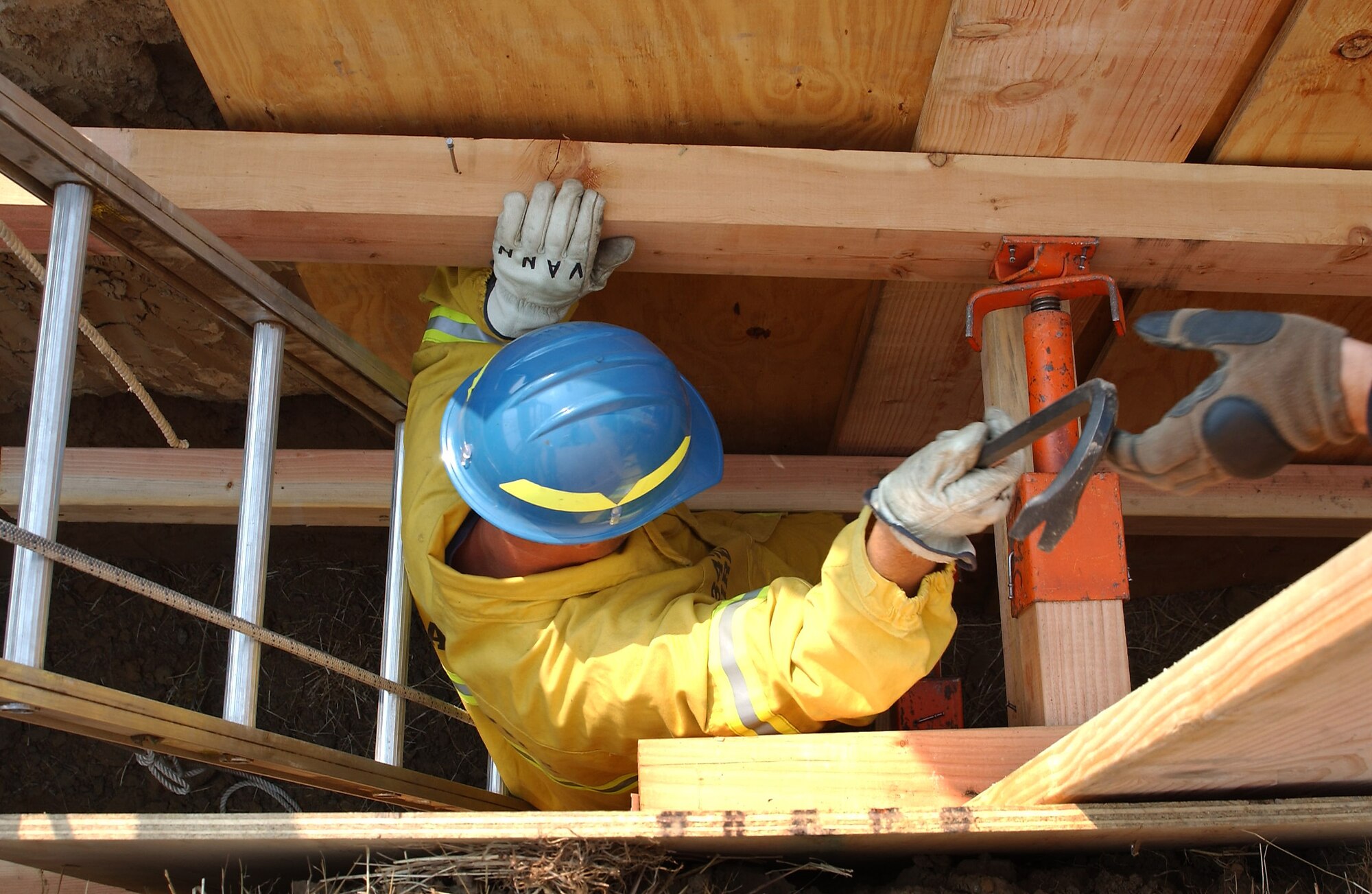 Scott Vann, Travis Fire Department, installs wood shoring during a trench rescue training exercise, Aug. 11.  During the training rescuers learn how to recognize, evaluate and mitigate the dangers in order to design a plan that is safe for the victim and for the rescuer. (U.S. Air Force photo/ Senior Airman Liliana Moreno)

