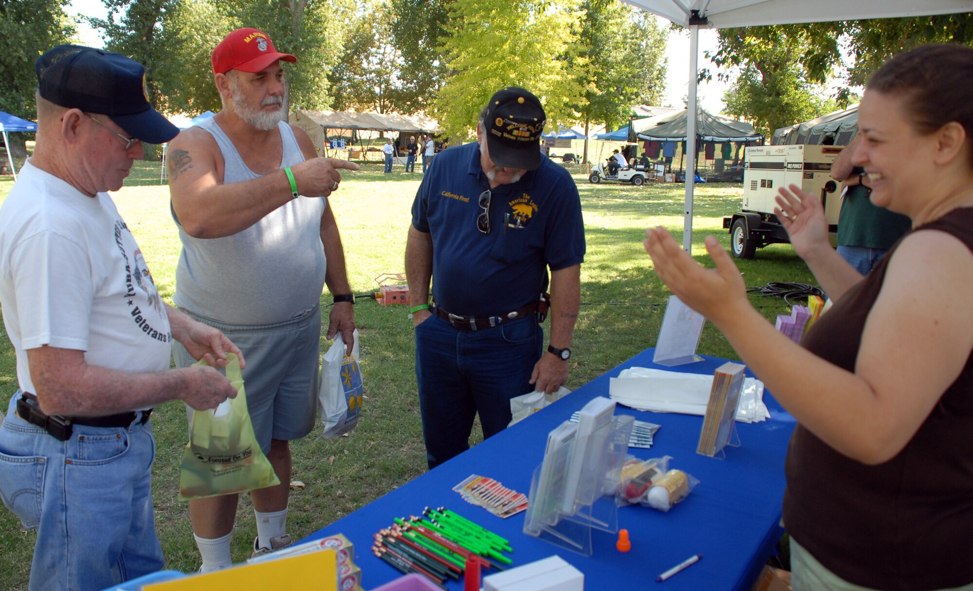 Karah Glavaris, Yuba County Public Health representative, talks with several veteran's, including Gene Downing (right), the American Legion District Commander, during the Yuba-Sutter Veteran's Stand Down at River Bottoms Park Aug. 20. (Photo by Staff Sgt. Sarah Brown)

