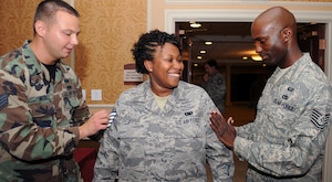 LANGLEY AIR FORCE BASE, Va. -- Staff Sgt. Travis Weeks and Tech. Sgt. David Bethel, 2nd Mission Readiness Squadron manpower analysts, pin staff sergeant on Senior Airman Karina Cooper, 735th Supply Chain Management Group supply journeyman, here Aug. 20.  Air Force officials selected 15,223 of 30,574 eligible senior airmen for promotion to staff sergeant for a selection rate of 49.79 percent. (U.S. Air Force photo/Airman 1st Class Gul Crockett)