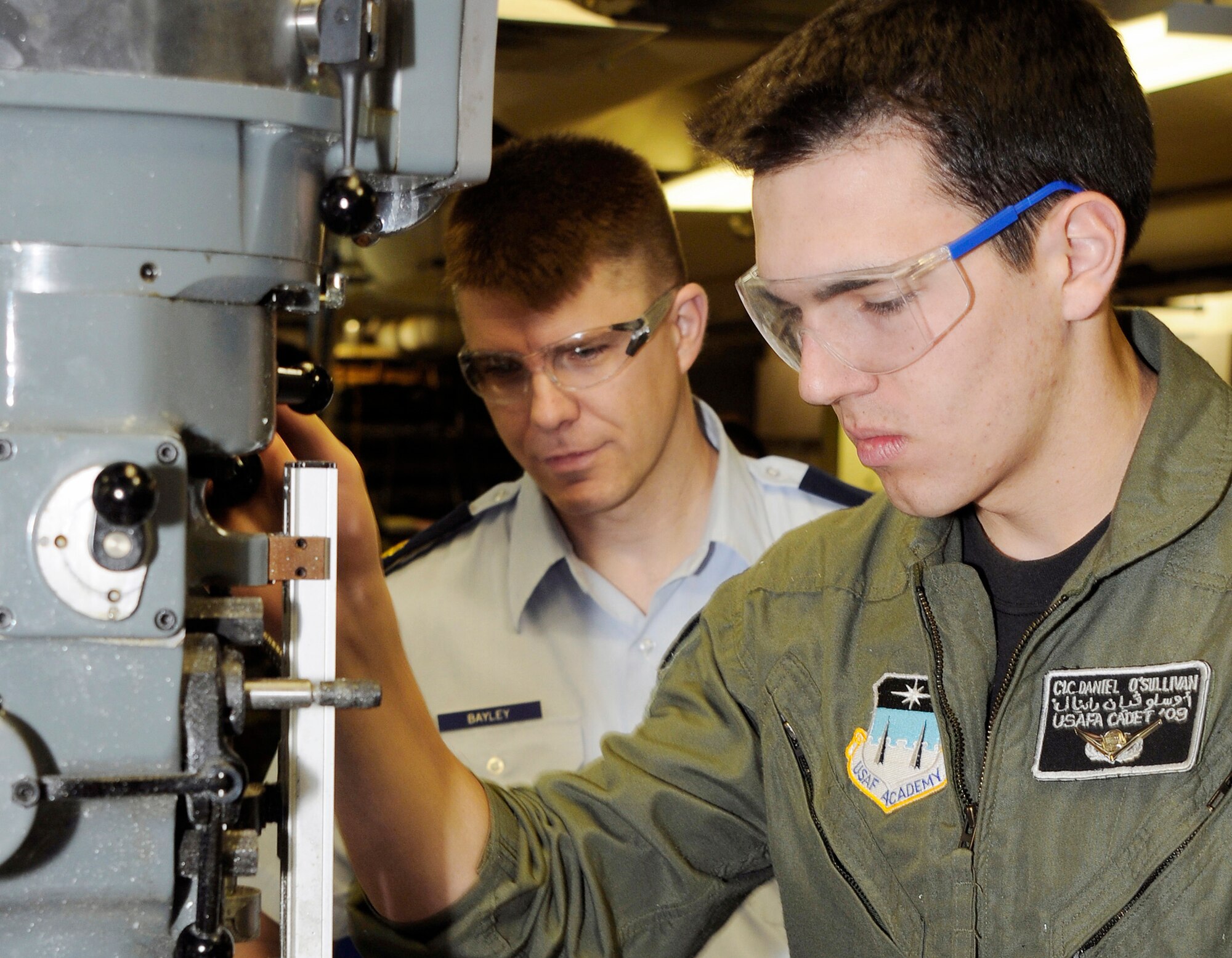 Maj. Douglas Bayley assists Cadet 1st Class Daniel O'Sullivan with a project in the U.S. Air Force Academy's astronautics laboratory Feb. 2. The Air Force Academy recently was ranked as the top undergraduate school in the western United States by U.S. News & World Report magazine. Major Bayley is an instructor with the Academy's Department of Astronautics. Cadet Sullivan graduated in May and now attends undergraduate pilot training at Columbus Air Force Base, Miss. (U.S. Air Force photo/Dave Ahlschwede)