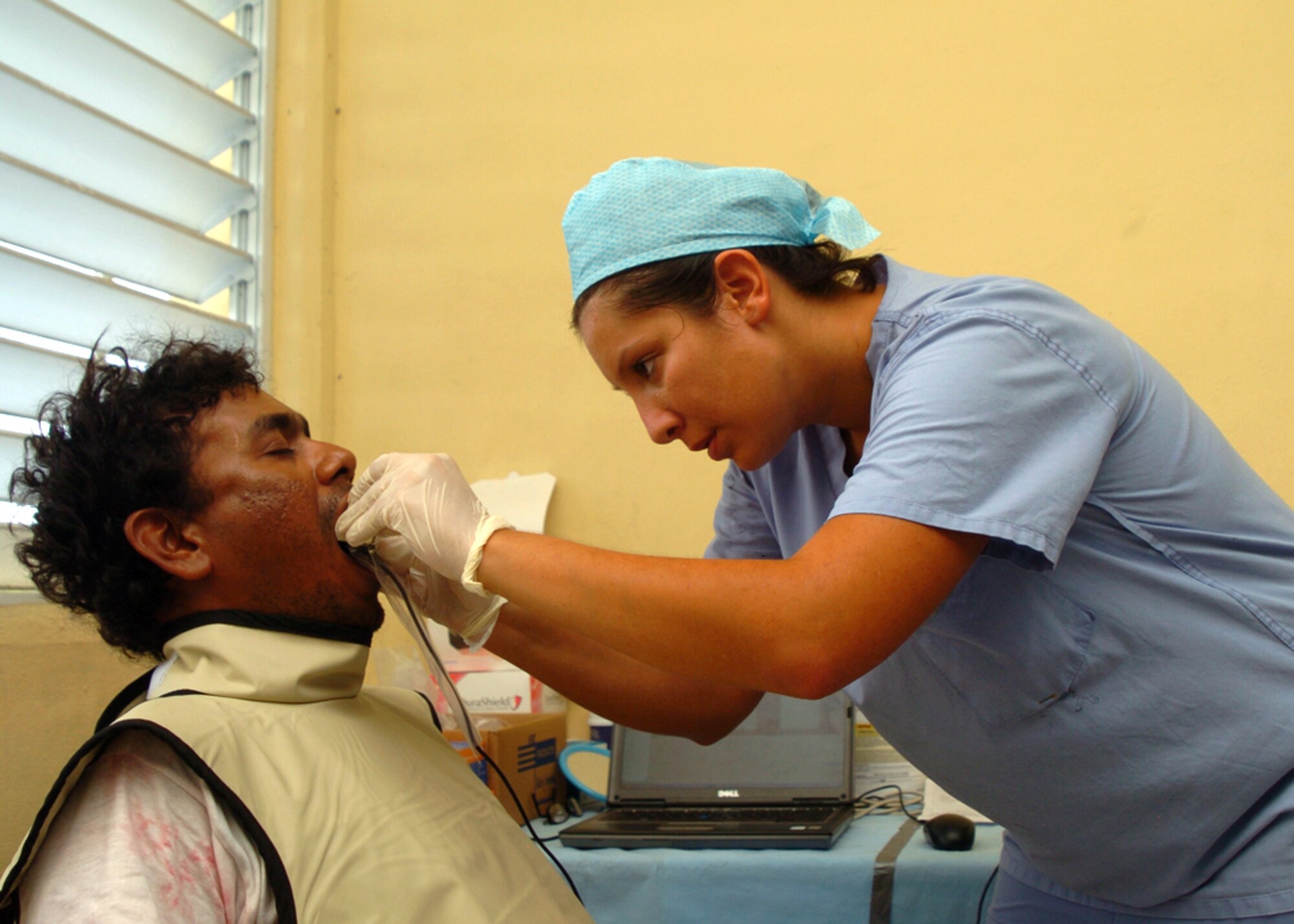 Staff Sgt. Shelley Thomas, 75th DS dental technician, prepares a Guyanese man for a dental x-ray. Sergeant Thomas is deployed to Guyana along with 13 other Hill Airmen in support of New Horizons Guyana 2009. These Airmen have only been working in Guyana for two days and have already provided free dental care to more than 120 Guyanese in need. (U.S. Air Force photo by Staff Sgt. Jason Burton)
