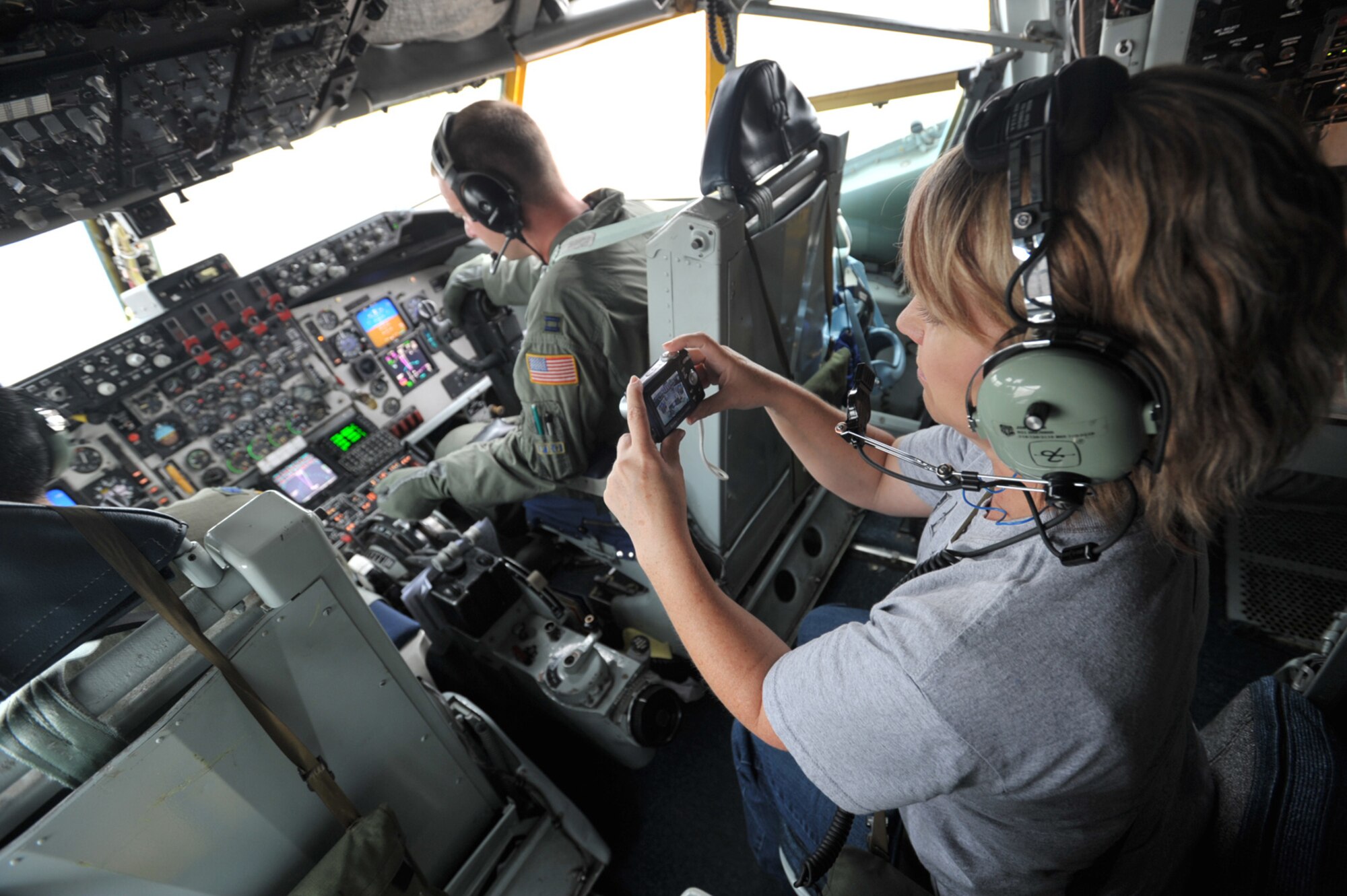 Jody Baker captures the moment with a camera while sitting in the cockpit of a KC-135 Stratotanker flown by an aircrew from the 931st Air Refueling Group. Baker is the principal of Meadowlark at Prairie Creek Elementary School in Derby, Kan., and the honorary commander of the 931st ARG's Operations Support Flight. She and other honorary commanders of active-duty units at McConnell Air Force Base, Kan., were invited to fly with the 931st crew during an aerial refueling mission on Aug. 15. (U.S. Air Force photo/Tech. Sgt. Jason Schaap)