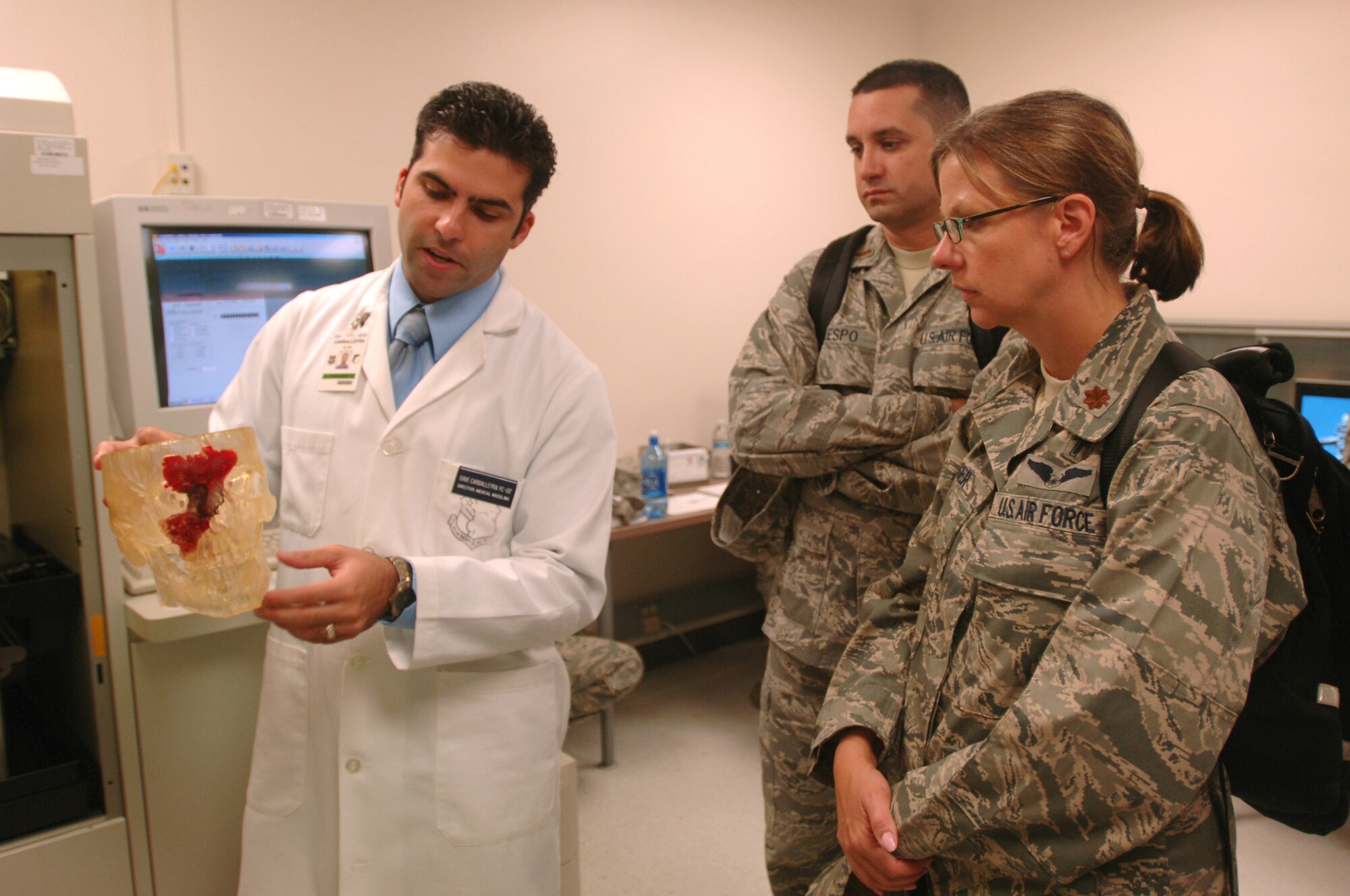 Mr. Alain Carballeyra, director of Stereolithography, 59th Dental Squadron, explains the stereolithography process to a chaplain and chaplain candidate using a model which outlines the extremities of a tumor on Aug.11 at MacKowan Dental Clinic, Lackland Air Force Base, Texas.  About 30 Air Force reservists throughout the United States toured Wilford Hall Medical Center to get a glimpse of a military chaplain's role in medical ministry. The reservists are part of the Air Force Chaplain Candidate Intensive Internship Program, which introduces candidates to a wide range of Air Force missions and opportunities for ministry. (Air Force photo/Senior Airman Nicole Roberts)

