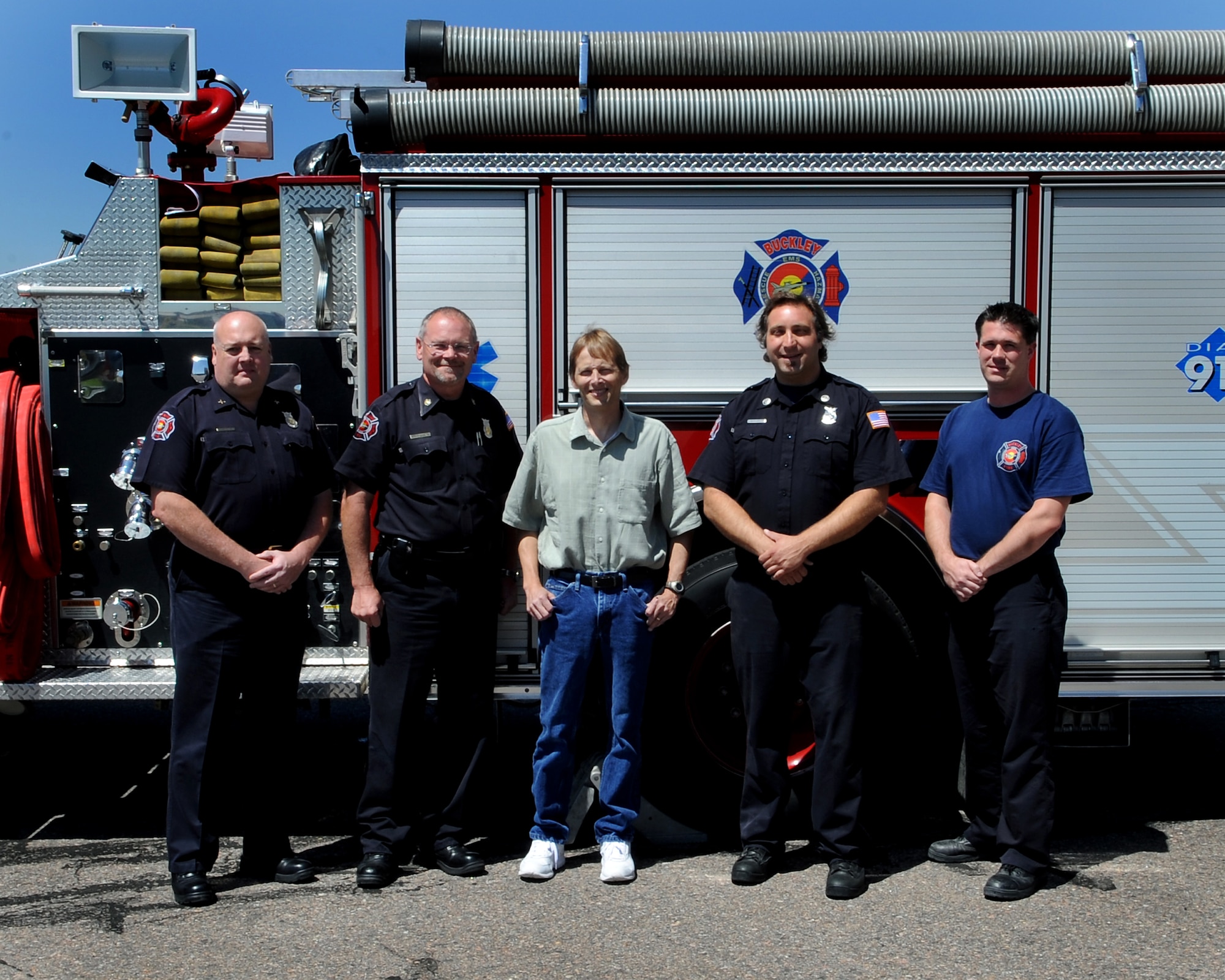 BUCKLEY AIR FORCE BASE, Colo. -- Team Buckley firefighters meet with cardiac arrest victim Dean Grover (center) for the first time since they saved his life May 26. The firefighters are (from left to right) Doug Collins, Chief Dennis Hoke, Jeff Santomango and Jeremy Collette. All have emergency medical technician training; Chief Hoke is also a paramedic. (U.S. Air Force photo by Senior Airman Erika Brooke)