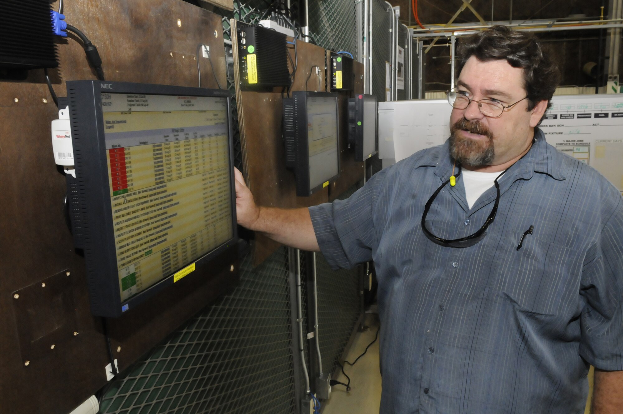 Michael Kazenstein, HVM workflow team lead, checks computer screens to keep track of daily progress and flow on the HVM aircraft. U. S. Air Force photo by Sue Sapp