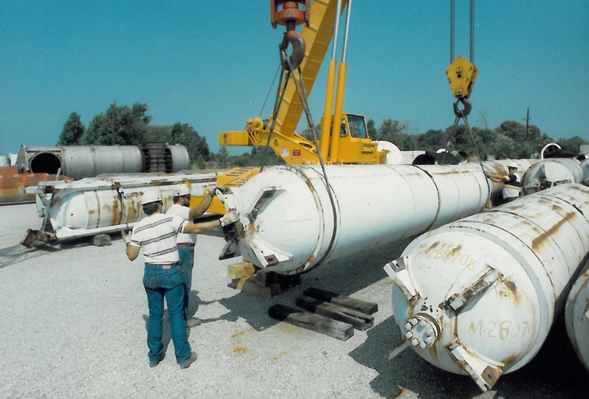 Riggers, who worked for the mission support contractor in the 1990s, prepare surplus pressure vessels to replace noncompliant existing Aerodynamic and Propulsion Test Unit storage vessels. This was a significant cost avoidance through PHMS certification progam.  (Photo courtesy of Bob Walker)