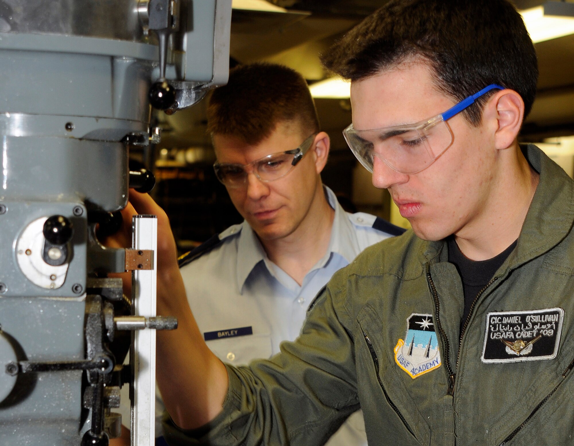 Maj. Douglas Bayley assists Class of 2009 Cadet Daniel O'Sullivan with a project in the U.S. Air Force Academy's astronautics laboratory Feb. 2, 2009. The Air Force Academy was recently ranked as the top undergraduate school in the western United States by U.S. News and World Report magazine. Major Bayley is an instructor with the Academy's Department of Astronautics. Cadet Sullivan graduated in 2009 and now attends undergraduate pilot training at Columbus Air Force Base, Miss. (U.S. Air Force photo/Dave Ahlschwede)