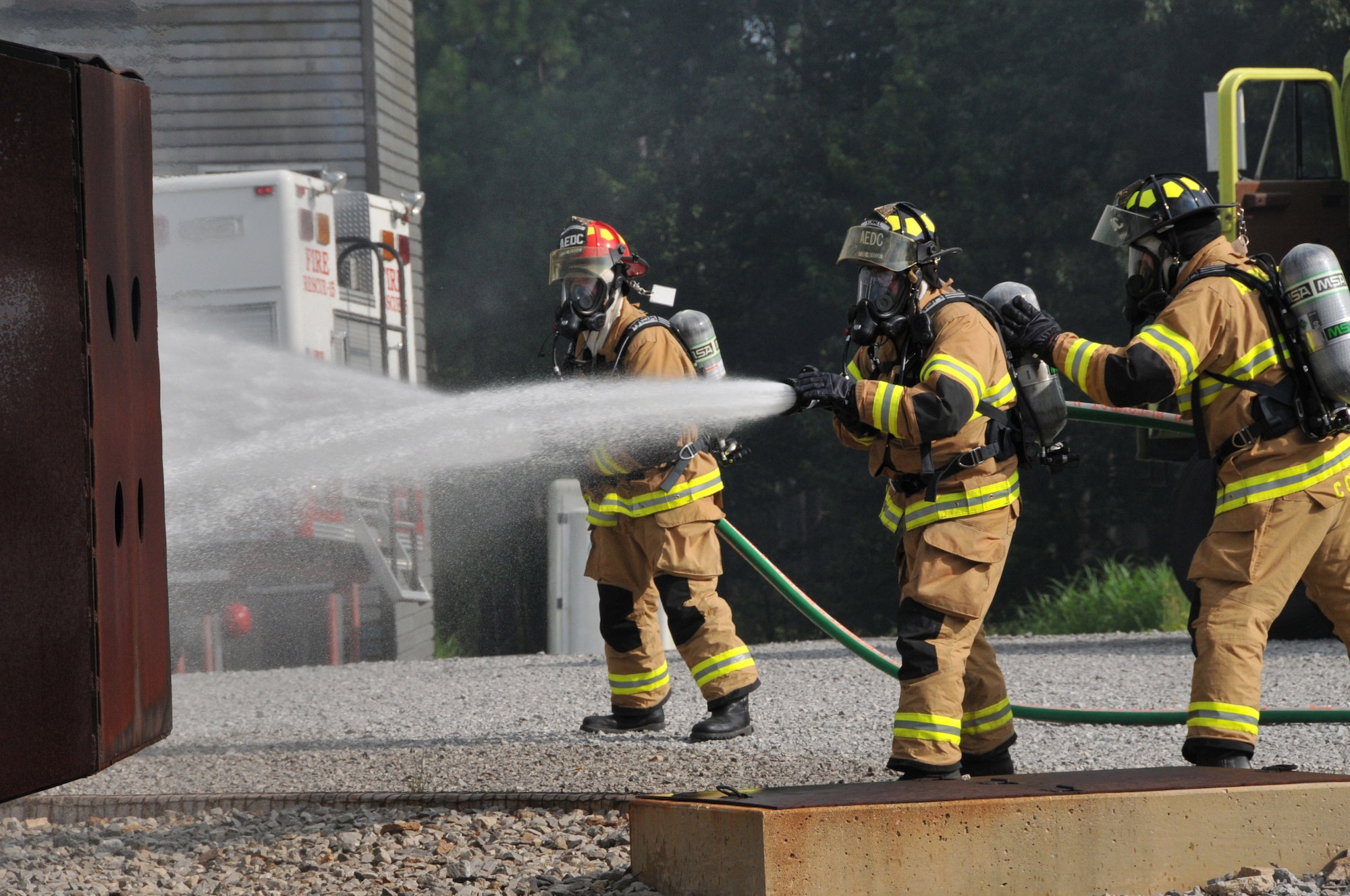 Above, Arnold Engineering Development Center firefighers put out the fire on the simulated fuselage of a C-130 during the exercise.  (Photo by Rick Goodfriend) 