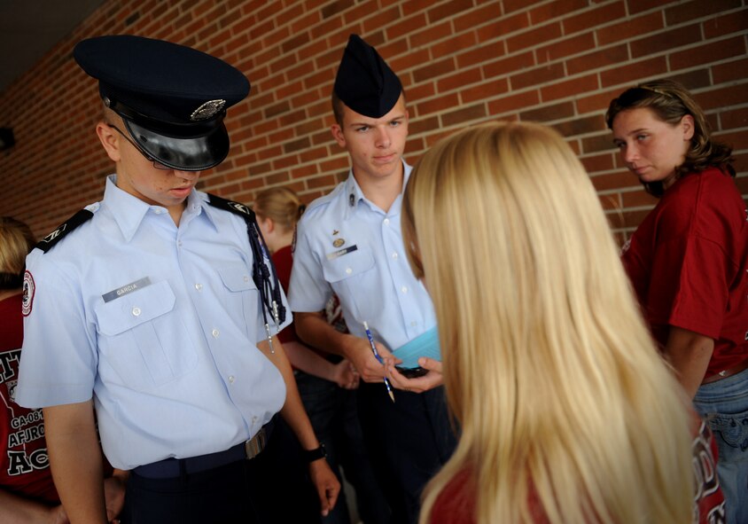 MOODY AIR FORCE BASE, Ga. -- Cadet 1st Lt. Jeffrey Garcia and Cadet Master Sgt. Cameron Gary, AFJROTC students at Lowndes County High School, Valdosta, Ga.,  perform a uniform inspection Aug. 18. Cadets without uniforms are still required to meet certain requirements while wearing their JROTC T-shirt. (U.S. Air Force photo by Senior Airman Gina Chiaverotti-Paige)