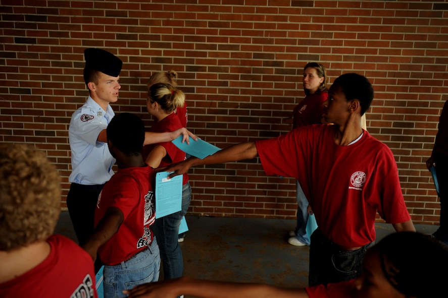 MOODY AIR FORCE BASE, Ga. -- Cadet Master Sgt. Cameron Gary, JROTC student, shows new cadets the proper way to perform open ranks before a uniform inspection at Lowndes County High School in Valdosta, Ga., Aug. 18. New cadets wear T-shirts until they are issued all of their uniform items. (U.S. Air Force photo by Senior Airman Gina Chiaverotti-Paige)