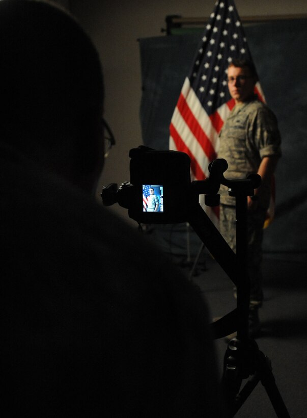 LANGLEY AIR FORCE BASE, Va. -- Chief Master Sgt. Kevin Slater, 1st Fighter Wing command chief, photographs Airman 1st Class Jason Brown, 1st FW Public Affairs journalist, after learning studio techniques during his tour here Aug. 20.  Chief Slater learned basic tasks performed by photographers, broadcasters, and journalists during his tour of PA. (U.S. Air Force photo/Airman Rebecca Montez)