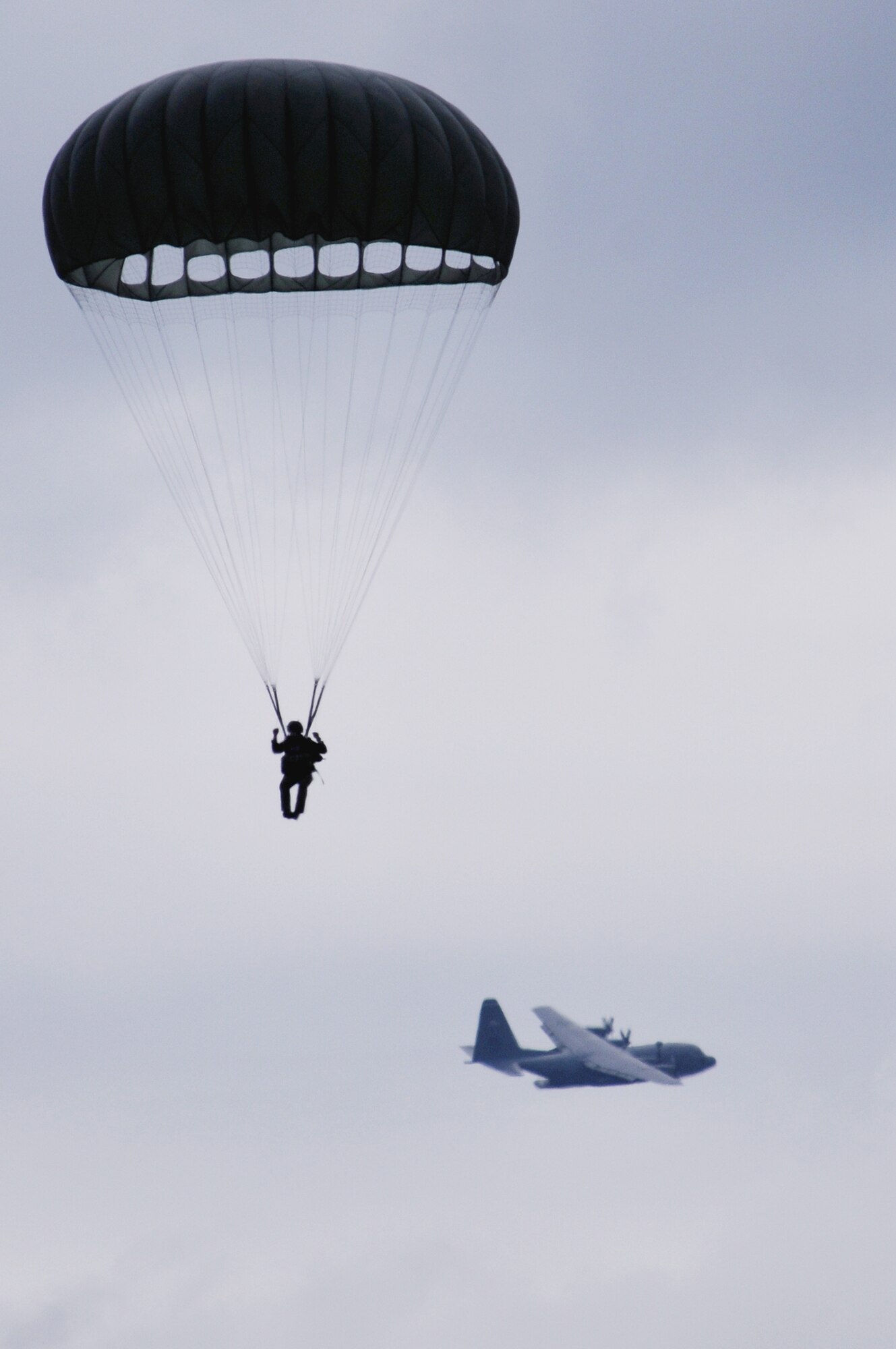 A U.S. soldier parachutes off a C-130 Hercules over the Bunker drop zone Aug. 13 in southwestern Germany. U.S. Soldiers and Airmen did a combined airborne drop with four other NATO countries. (U.S. Air Force photo/Airman 1st Class Grovert Fuentes-Contreras)