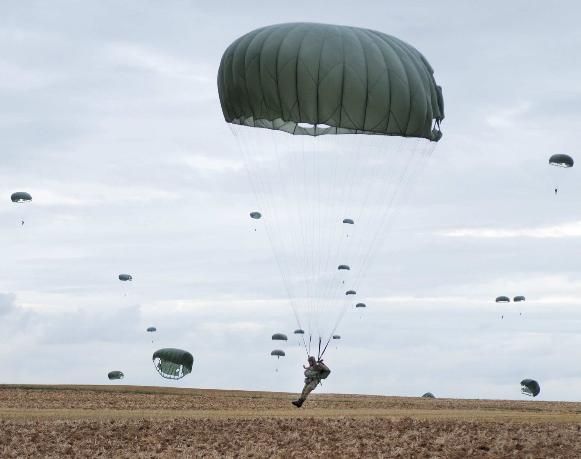 Italian army soldier Giovanni Cacciari lands after parachuting out of a C-130 Hercules at the Bunker drop zone Aug. 13 in southwestern Germany. U.S. Soldiers and Airmen performed a combined airborne drop with four other NATO countries during International Jump Week. (U.S. Air Force photo/Airman 1st Class Grovert Fuentes-Contreras) 