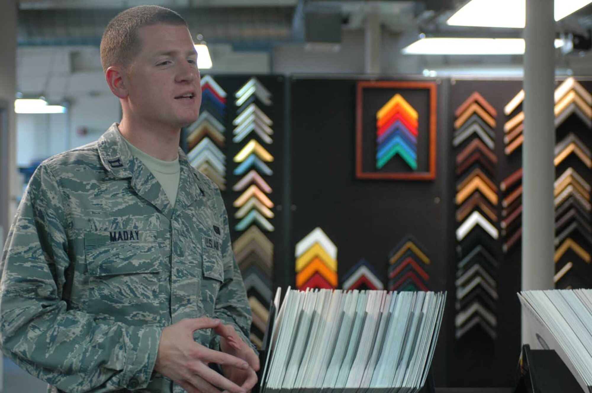 Capt. Sean Maday, 60th Operations Group, stands in the Framing Shop at Travis’Arts and Crafts Center. Molding of many shapes, sizes and colors adorns the walls behind him. (U.S. Air Force photo/Nick DeCicco)


