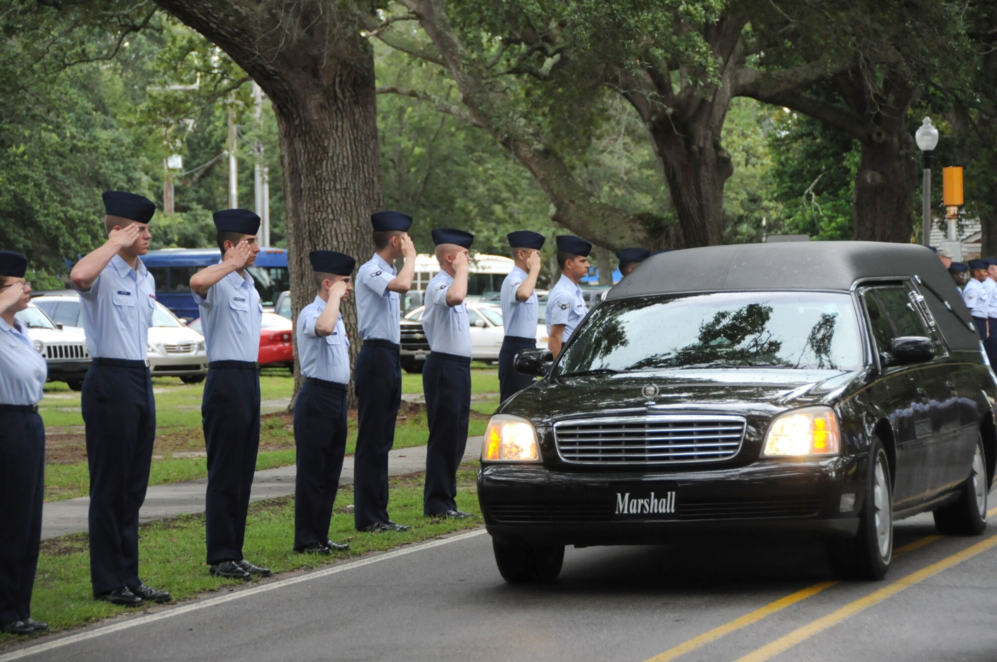 Students from the 81st Training Group salute the body of Army Staff Sgt. Johnny Polk at Biloxi National Cemetery before his burial service, Saturday.  Sergeant Polk, 39, grew up in Gulfport.  He died July 25 from wounds he received while serving in Iraq.  (U.S. Air Force photo by Kemberly Groue)