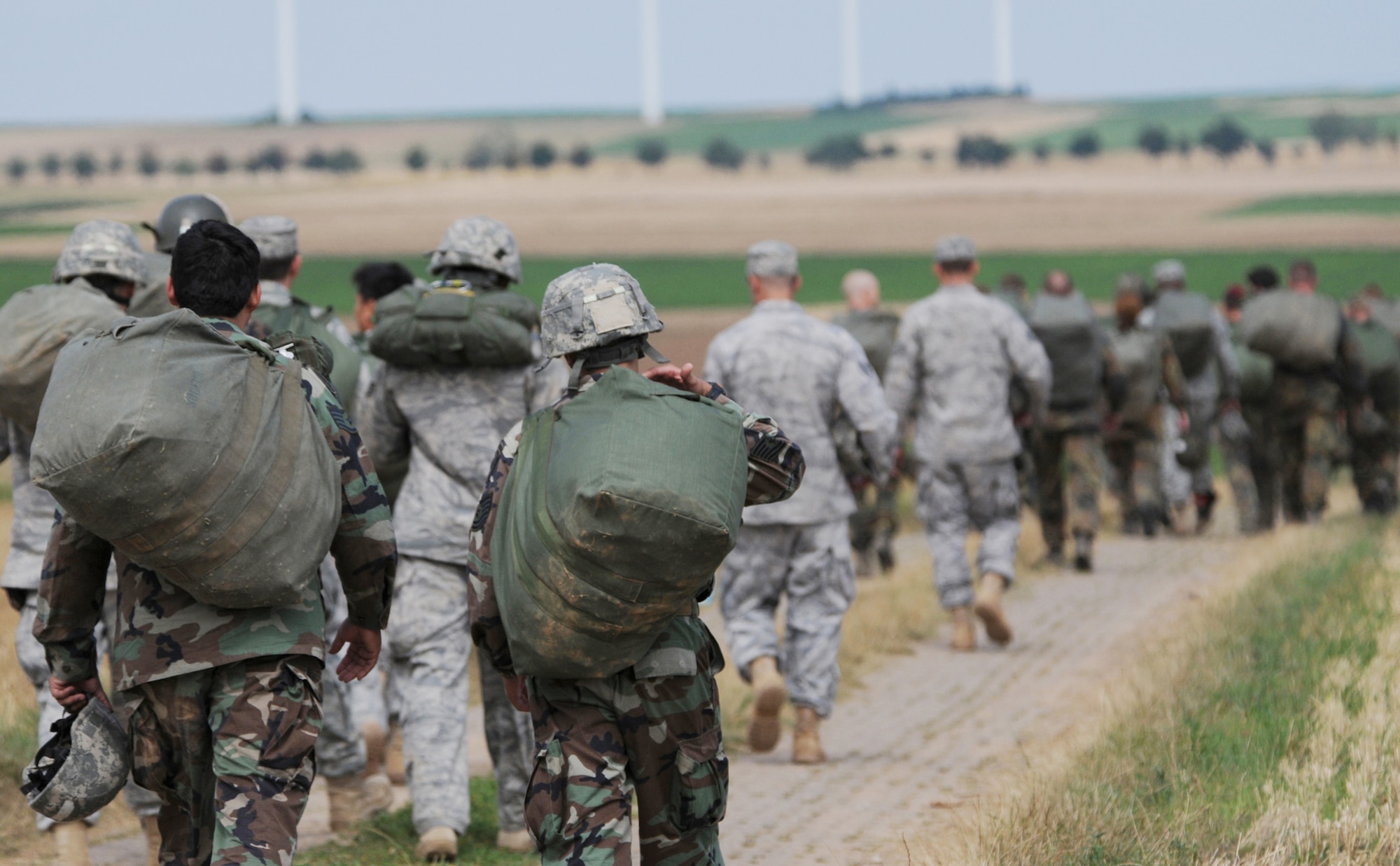U.S. forces along with German, Italian, Belgium and Dutch armies march back after landing at the Bunker drop zone Aug. 13 in southwestern Germany. U.S. Soldiers and Airmen performed a combined airborne jump with four other NATO countries during International Jump Week. (U.S. Air Force photo/Airman 1st Class Grovert Fuentes-Contreras) 