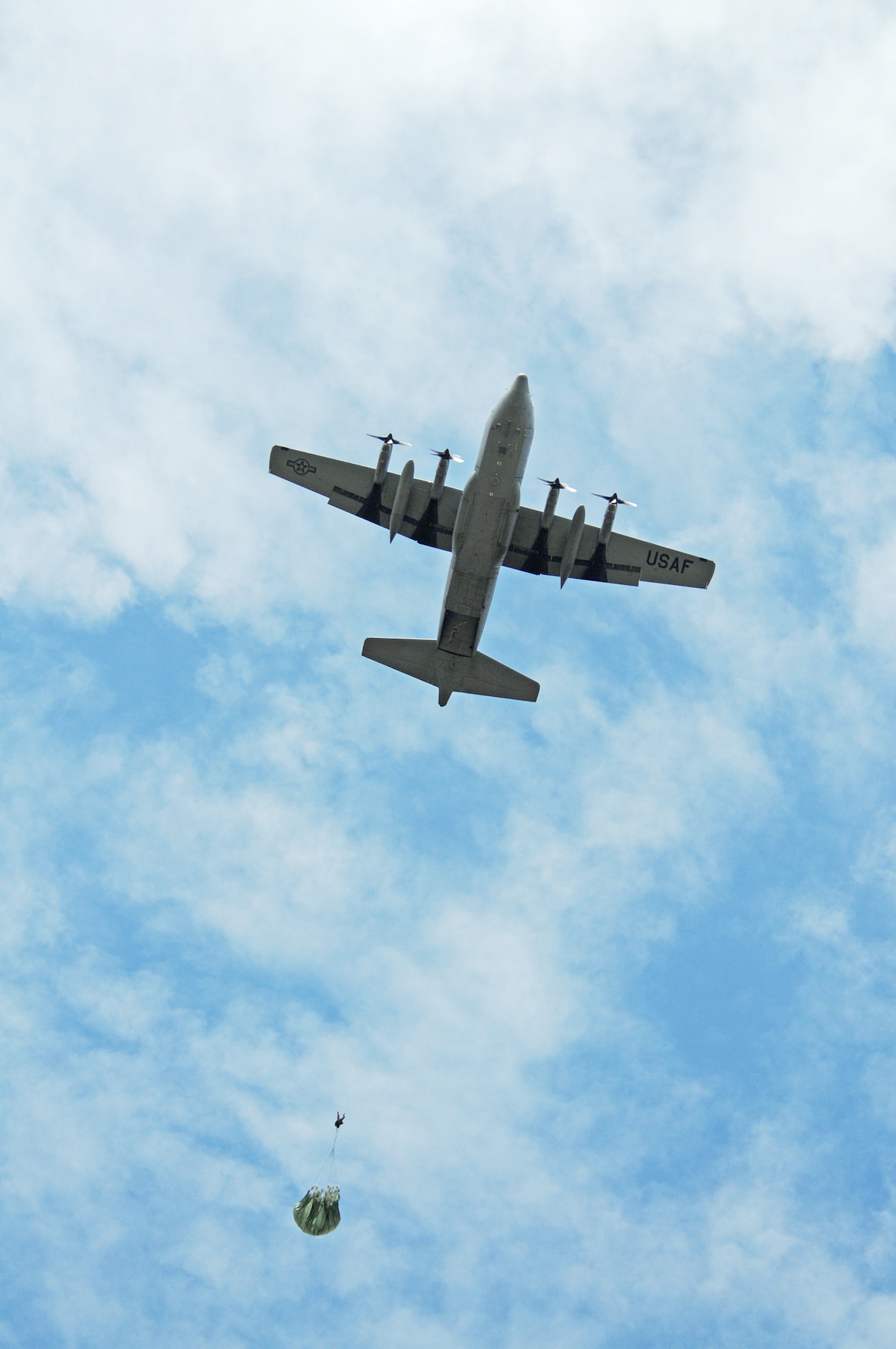 Col. Timothy Brown parachutes out of a C-130 Hercules over the Bunker drop zone Aug. 13 in southwestern Germany. U.S. Soldiers and Airmen performed a combined airborne jump with four other NATO countries during International Jump Week. Colonel Brown is the 86th Contingency Response Group commander. (U.S. Air Force photo/Airman 1st Class Grovert Fuentes-Contreras) 