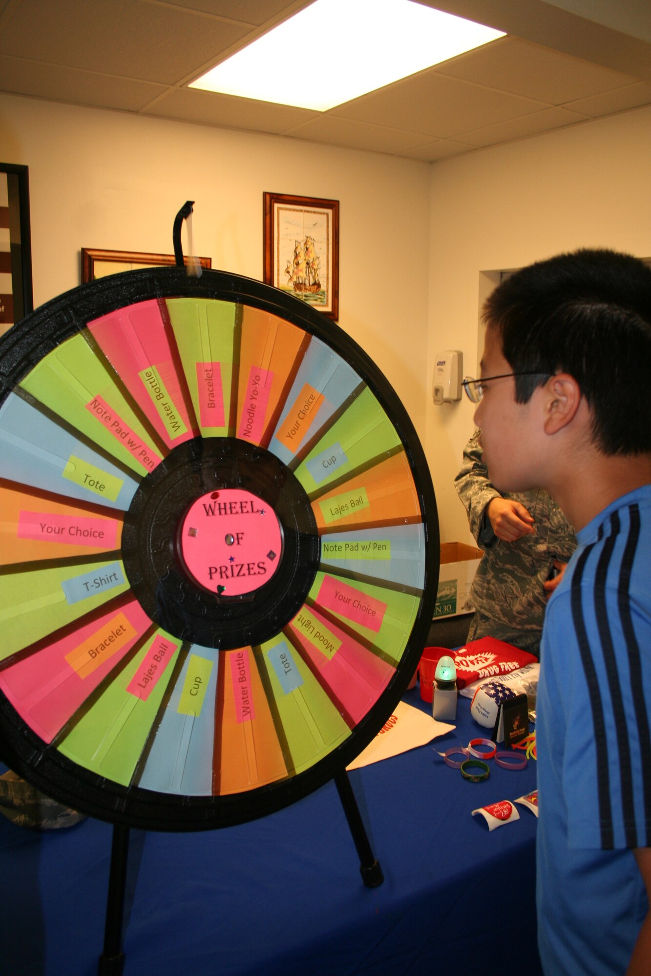 Yohei, who is the son of Hitomi Sparks, a dependent here at Lajes Field, watches as the “Wheel of Prizes” spins while he waits to find out what he has won for answering a question about health and wellness correctly at the health fair during the School and Sports Physical Day held at the Lajes Field clinic Aug 20. The health fair highlighted dental education, physical fitness tips and health and wellness information. During this one day event, the 65th Medical Group handled around 120 appointments preparing the children at Lajes Field for the new school year and to be able to participate in youth sports. (U.S. Air Force photo by Capt. George Tobias)