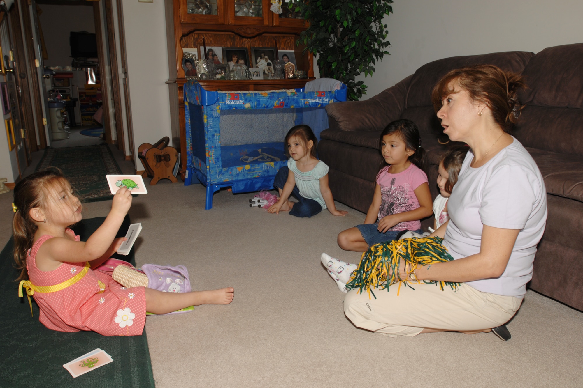 Fernanda Pofahl, a credited affiliate child-care provider, plays show-and-tell with children she provides care for at her home in Wichita, Kan. Fernanda has been an affiliated provider for the Air Force for more than 10 years. (U.S. Air Force photo/Staff Sgt. Jamie Train) 