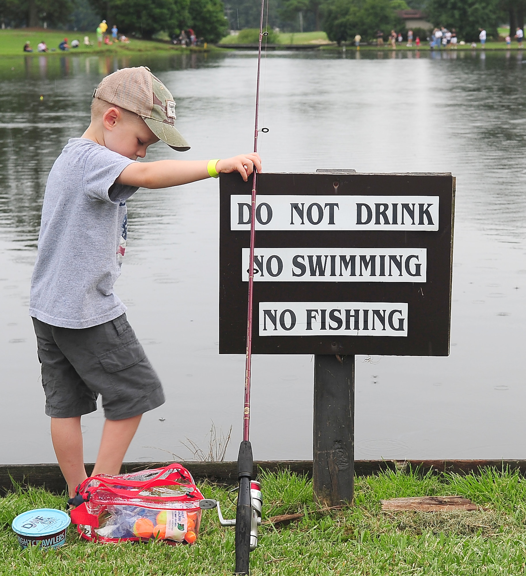 Mark Hoffer, son of Tech Sgt. Shawn Hoffer, 4th Aircraft Maintenance Squadron, waits for a bite by the no fishing sign during the fishing derby at Seymour Johnson Air Force Base, N.C., Aug. 16, 2009. The derby was an exception to the no fishing rule at the Three Eagles Golf Course lake when more than 135 anglers were allowed the chance for catch and release fishing. (U.S. Air Force photo by Airman 1st Class Rae Perry) 