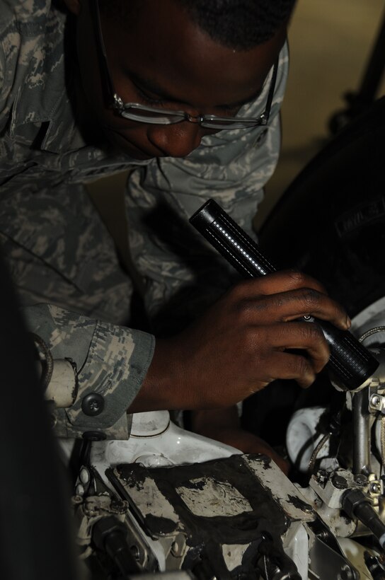 Airman 1st Class Lloyd Brown, 28th Maintenance Squadron crew chief, inspects the B-1B Lancer's forward landing gear for any discrepancies here, August 19.  Airman Brown inspects every area on the landing gear, paying special attention to the braking system. (U.S. Air Force photo/Airman 1st Class Anthony Sanchelli)
