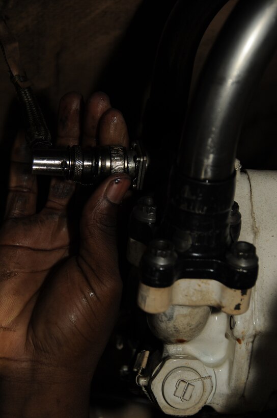 Airman 1st Class Lloyd Brown, 28th Maintenance Squadron crew chief, checks the B-1B Lancer's accessory drive gear box, ensuring all lines are connected properly here, August 19.  Airman Brown checks over each area of the B-1 several times. (U.S. Air Force photo/Airman 1st Class Anthony Sanchelli)