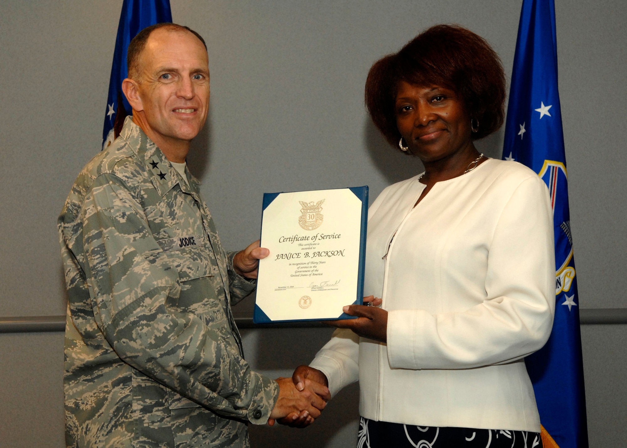 Maj. Gen. Ralph Jodice presents an award to Ms. Janice Jackson for 30 years of outstanding service to the federal government during an Aug. 14 ceremony. (Photo by Sgt. Melissa Stonecipher)
