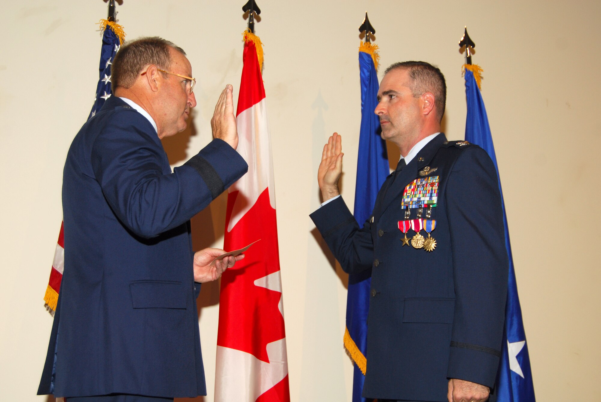 Maj. Gen. Hank Morrow, 1st Air Force commander, administers the oath of office to Col. George Uribe, 1st Air Force chief of Standardization and Evaluation, during his promotion ceremony.  Col. Uribe was promoted and presented with the Bronze Star Medal, the Meritorious Service Medal, and his fourteenth Air Medal. (U.S. Air Force photo by Lisa Norman)
