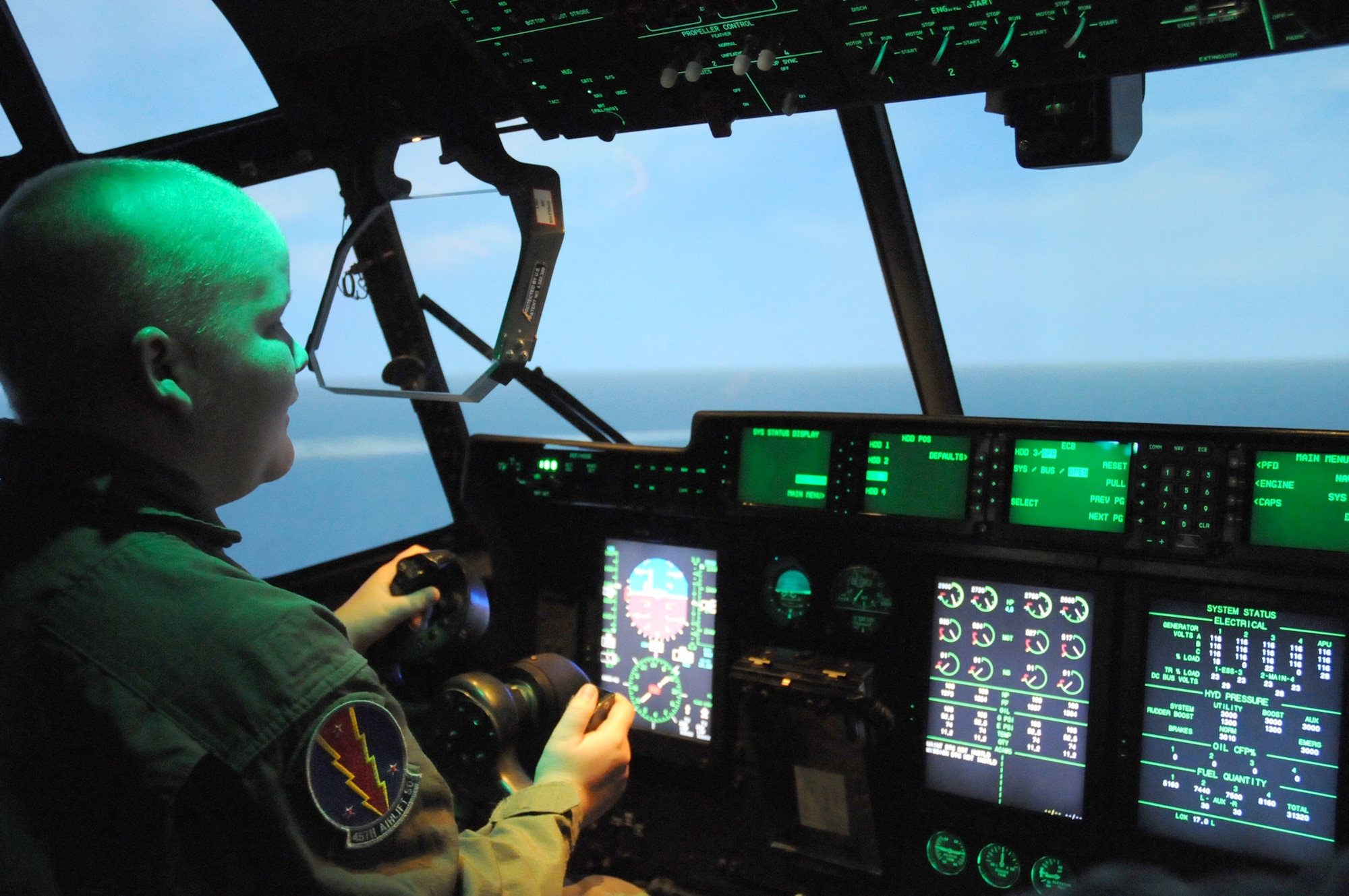 Thirteen-year-old Sean Peneguy of Bay St. Louis takes the controls of a C-130J simulator in Lott Hall Friday during a Keesler visit arranged by the 45th Airlift Squadron and the Make-A-Wish Foundation.  (U.S. Air Force photo by Kemberly Groue)