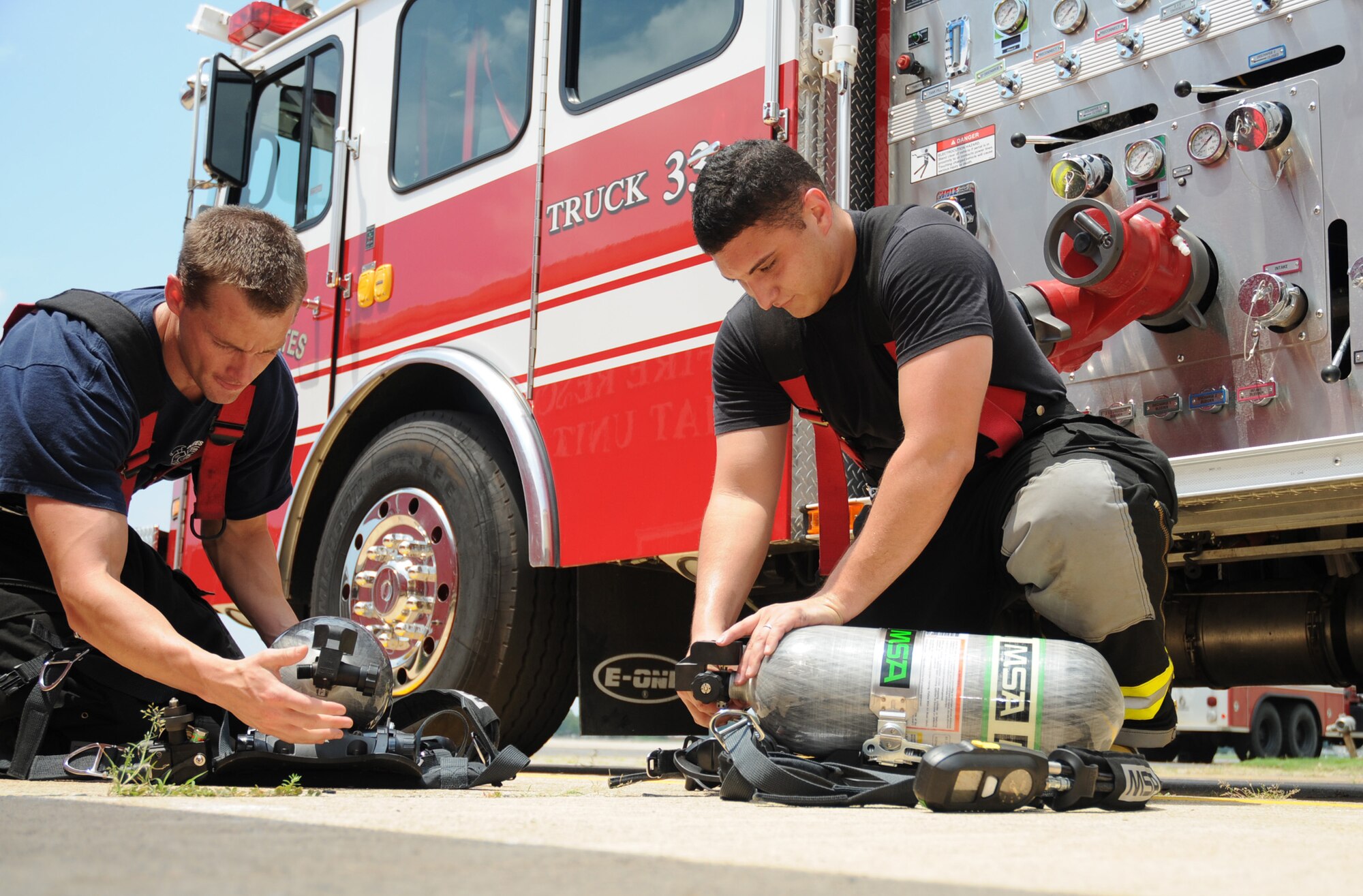 Firefighters Jason Wallace, left, and Senior Airman Roberto Rivera perform daily tests on the new breathing apparatus recently obtained by Keesler’s fire emergency services team.  (U.S. Air Force photo by Kemberly Groue)