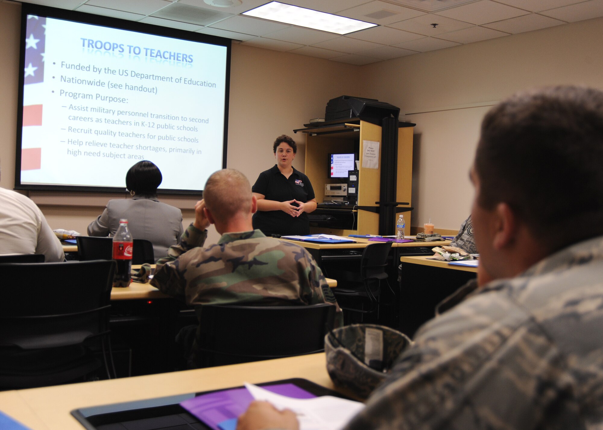 Colleen Schulteis, Troops to Teachers program representative from Fort Riley, Kan., speaks to several Team McConnell members at McConnell Air Force Base, on Aug. 18 about becoming a teacher after the military. (U.S. Air Force photo/Airman First Class Maria Ruiz)