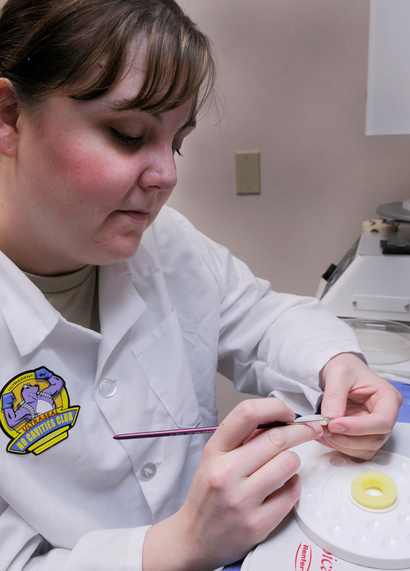 Staff Sgt. Bianca Roth glazes a porcelain fuse metal crown at the dental clinic Aug. 19, 2009, Eielson Air Force Base, Alaska. The 354th Dental Clinic makes several prosthetics in their lab; reducing the amount of time patients have to wear temporary prosthesis. Sergeant Roth is a dental lab technician assigned to the 354th Medical Group. (U.S. Air Force photo/Airman 1st Class Laura Goodgame)