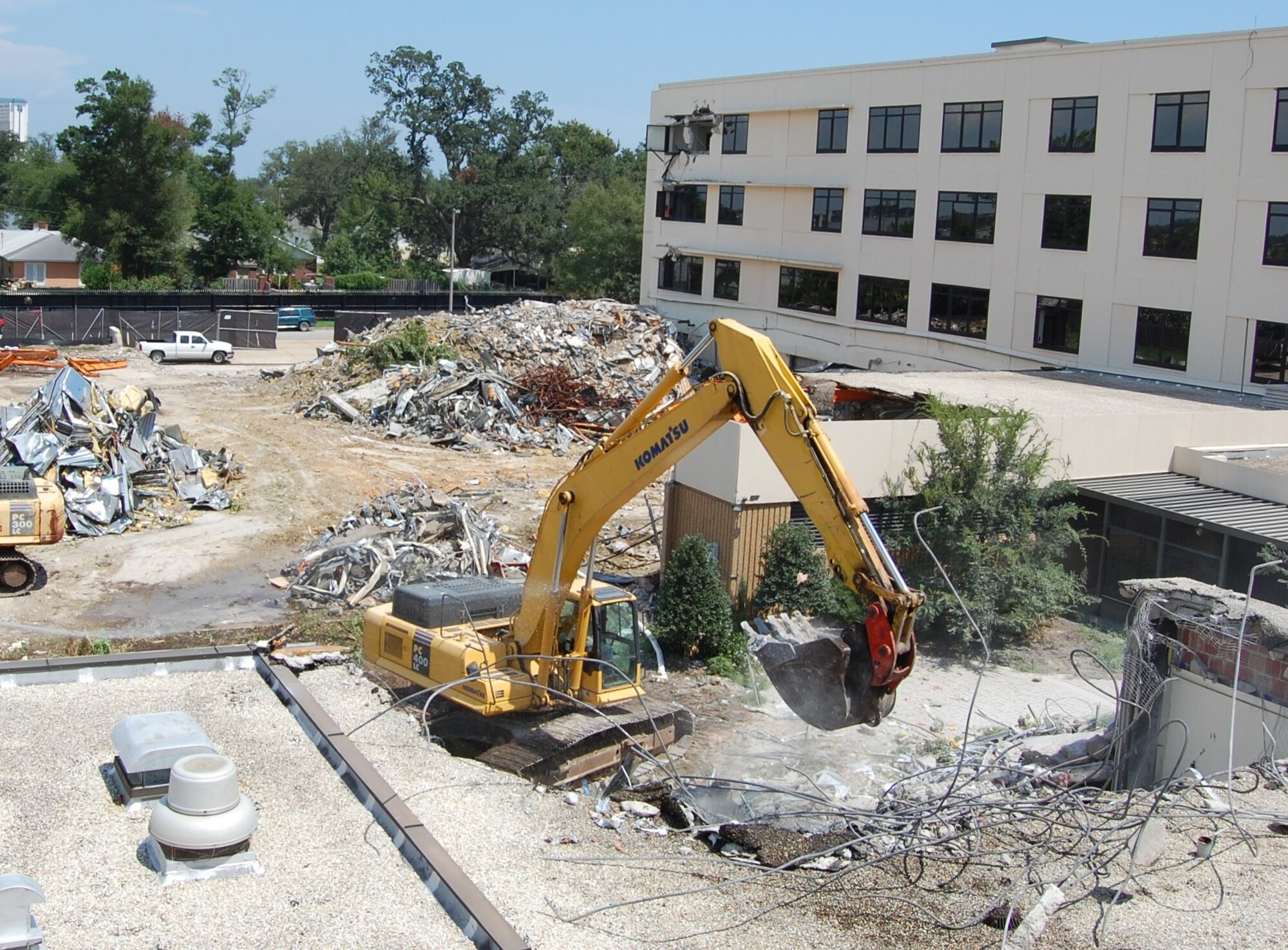 Contractors with Carothers Construction demolish the former physical therapy clinic area of Keesler Medical Center's "D" wing Aug. 11.  Demolition, including the main D wing tower in the background, is scheduled to be completed by Oct. 17.  It is being done to make way for the new $68 million inpatient tower.  Construction of the new tower is planned to start in late October, with completion scheduled for October 2011.  As the structures are demolished, the contractor is separating recyclable material from the debris.  (U.S. Air Force photo by Steve Pivnick)

