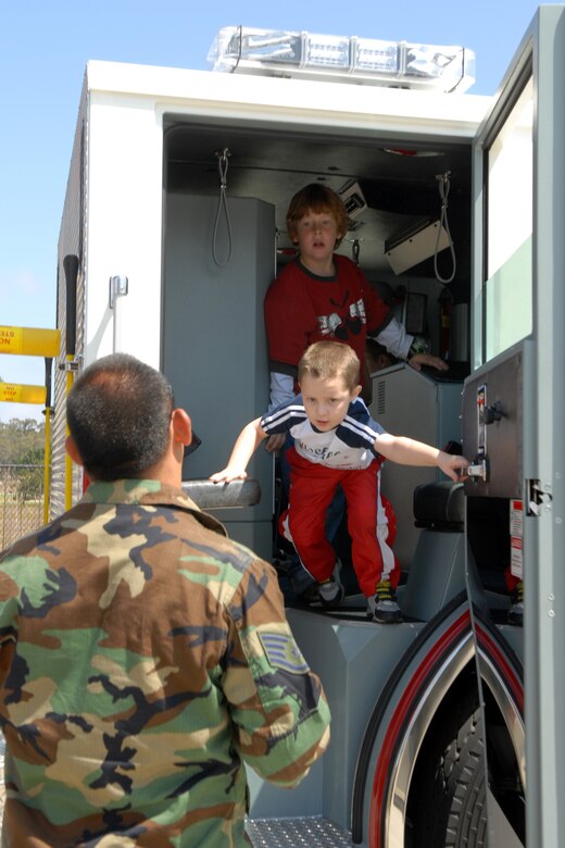 VANDENBERG AIR FORCE BASE, Calif. -- Exiting a fire truck, Roman Wankowski, who is the son of Capt. Timothy Wankowski of the 30th Security Forces Squadron, and Evan McMillan, who is the son of Master Sgt. John McMillin of the 614th Air and Space Operations Center, finish a lesson on firefighters' tools of the trade at the Kids’ Fire Camp on Aug.15 at Fire Station 2 here. The camp is used to boost public education on fire safety and hazards. (U.S. Air Force photo/Airman 1st Class Kerelin Molina)