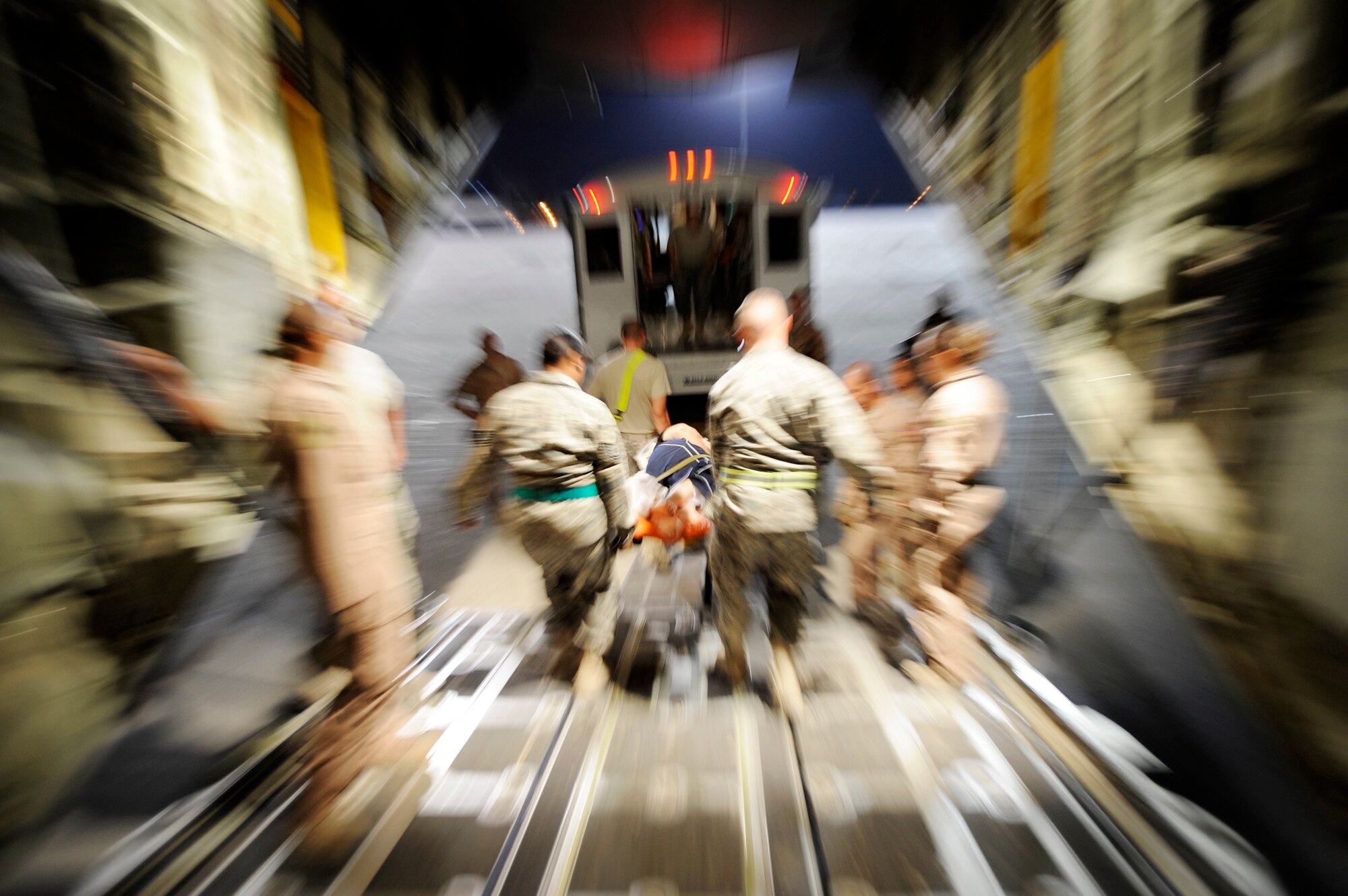 Airmen assigned to the 451st Expeditionary Aeromedical Evacuation Flight transport patients from a C-130J Super Hercules to an ambulance during an aeromedical evacuation mission to transport patients July 21 at Kandahar Airfield, Afghanistan. (U.S. Air Force photo/Staff Sgt. Shawn Weismiller)