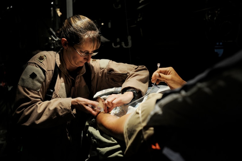 Maj. Missy Steckler provides care to a patient during a flight to a location that can provide a higher level of medical care. Major Steckler is a flight nurse assigned to the 451st Expeditionary Aeromedical Evacuation Flight at Kandahar Airfield, Afghanistan. (U.S. Air Force photo/Staff Sgt. Shawn Weismiller) 