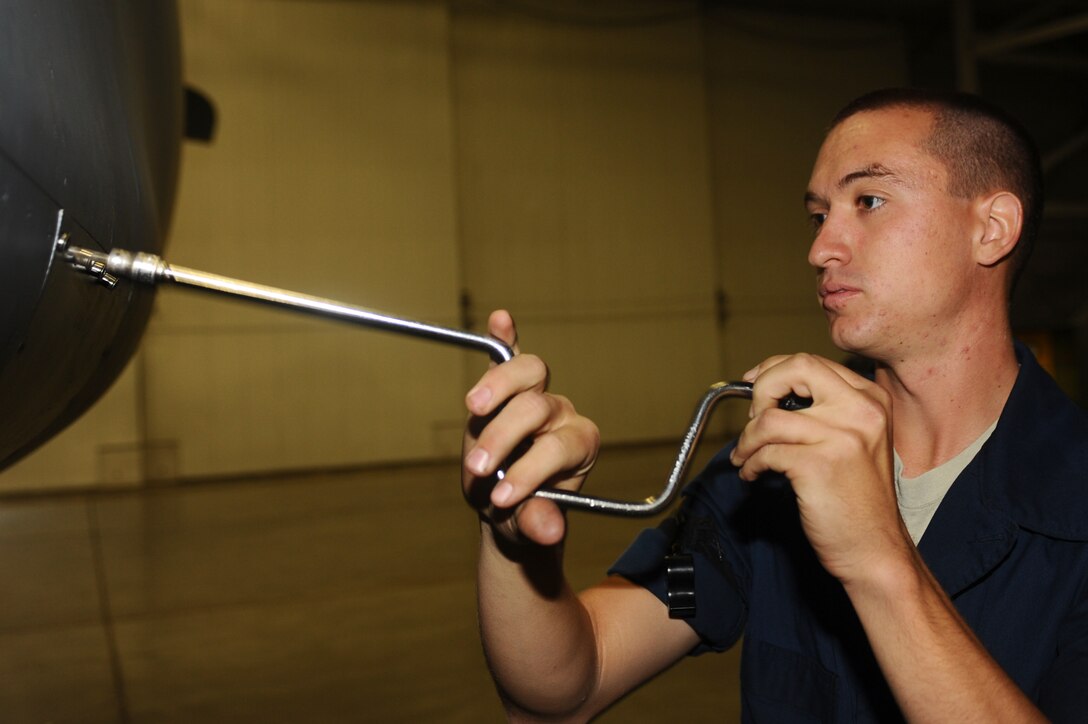 Senior Airman Brian Decker, 34th Aircraft Maintenance Unit crew chief, secures a hydraulic servicing panel on a B-1B Lancer here, August 19. Airman Decker ensures the B-1’s hydraulics are in proper working order. (U.S. Air Force photo/Senior Airman Kasey Zickmund)