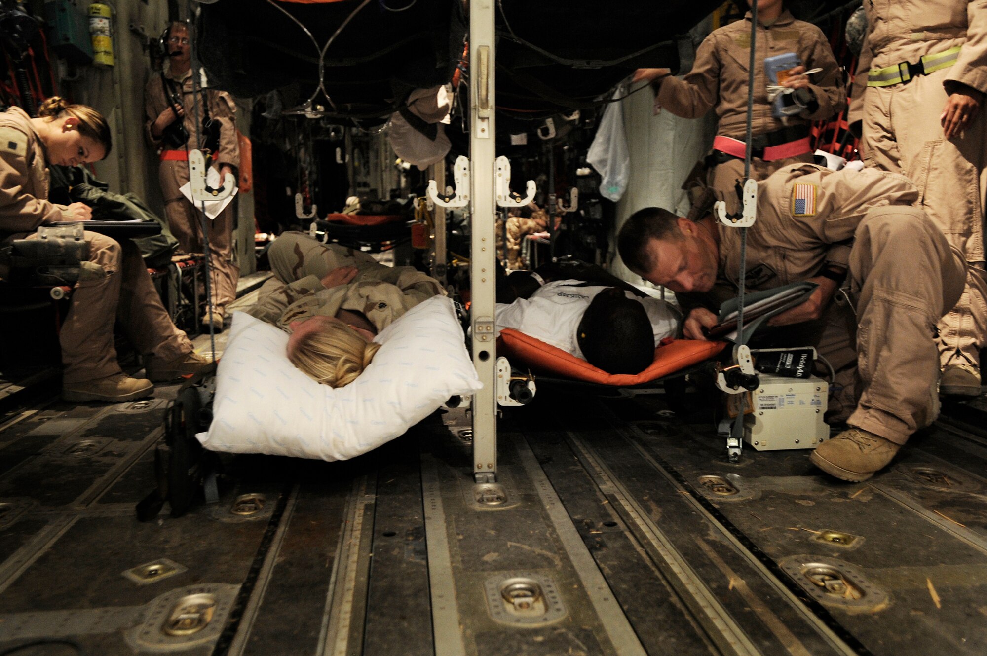 Master Sgt. Zachary Johnson cares for a patient during an aeromedical evacuation mission to transport patients July 19 from Kandahar Airfield, Afghanistan, to Bagram Airfield, Afghanistan. Sergeant Johnson is a 451st Expeditionary Aeromedical Evacuation Flight aeromedical technician. (U.S. Air Force photo/Staff Sgt. Shawn Weismiller) 
